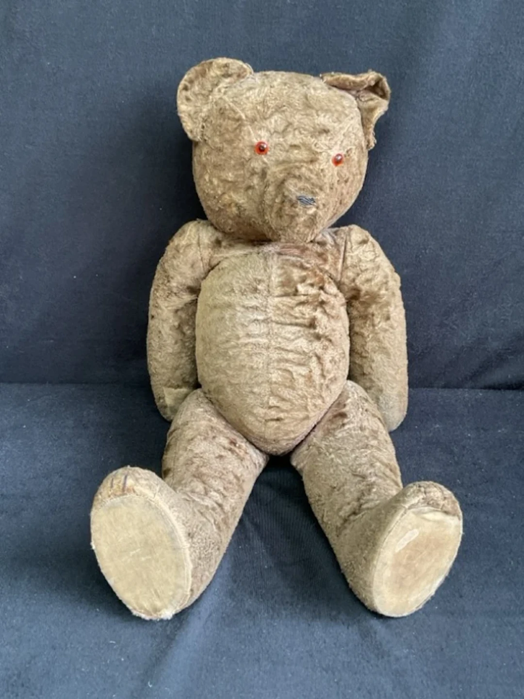 A 30s plush teddy bear with jointed limbs cotton paw pads, glass eyes