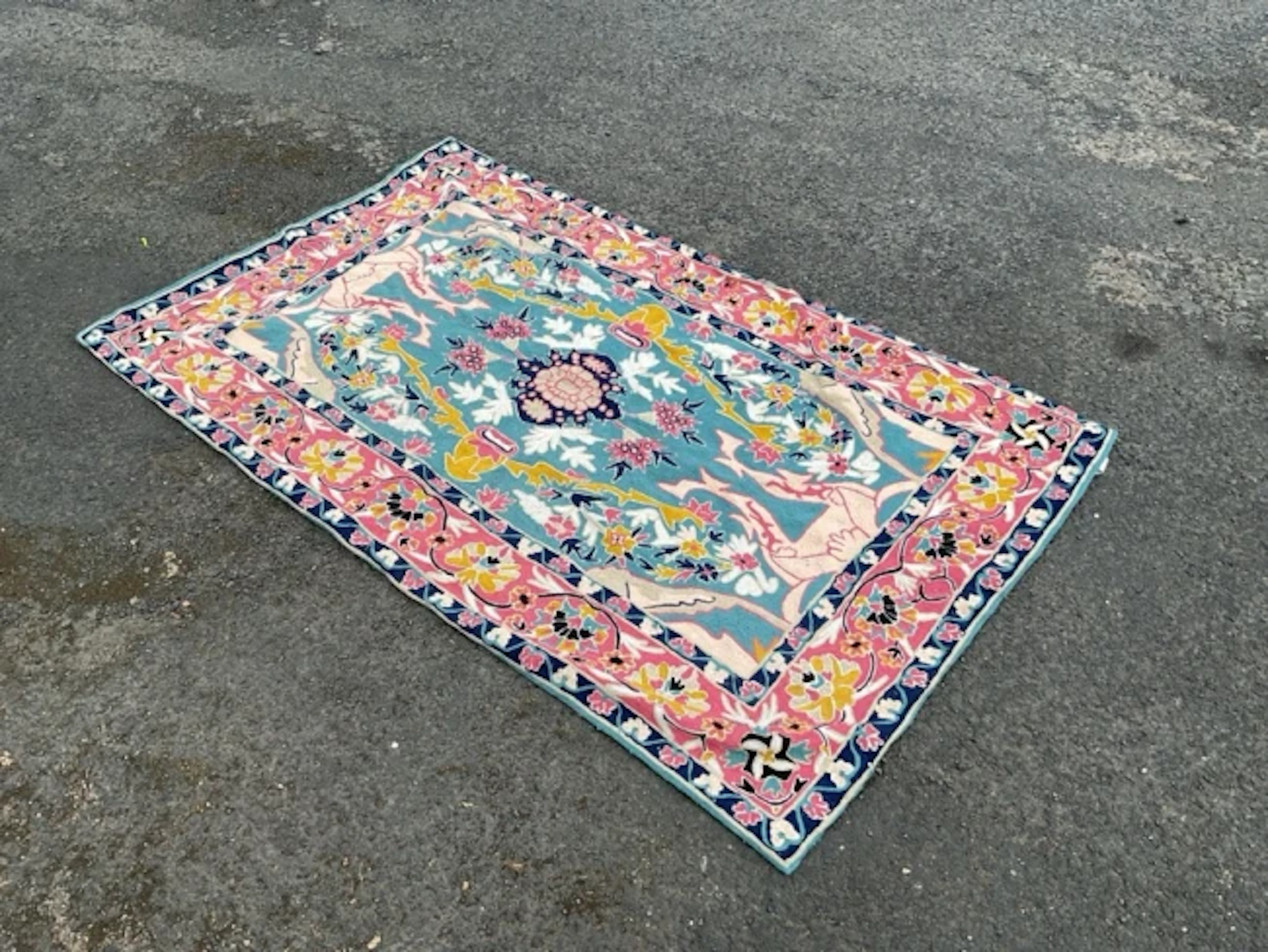 A Kashmiri chainstitch embroidered rug worked in wools on a cotton