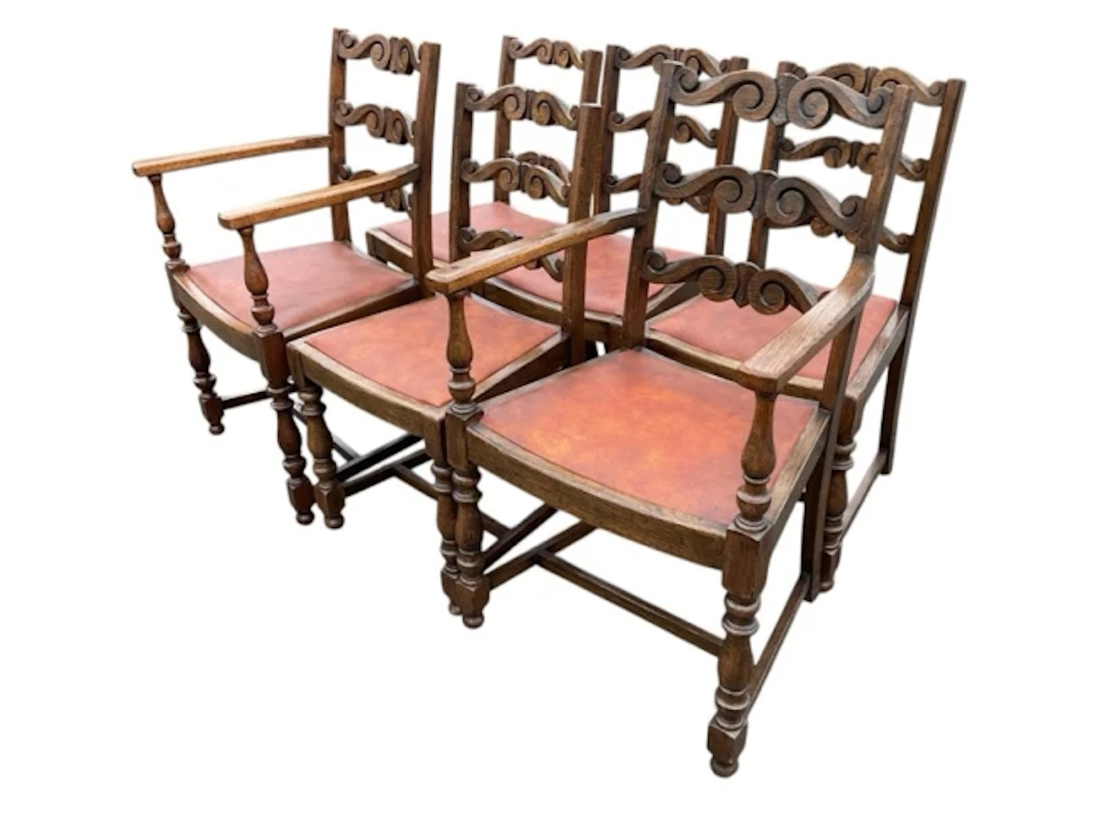 A set of six oak ladderback dining chairs, the backs with scroll carved