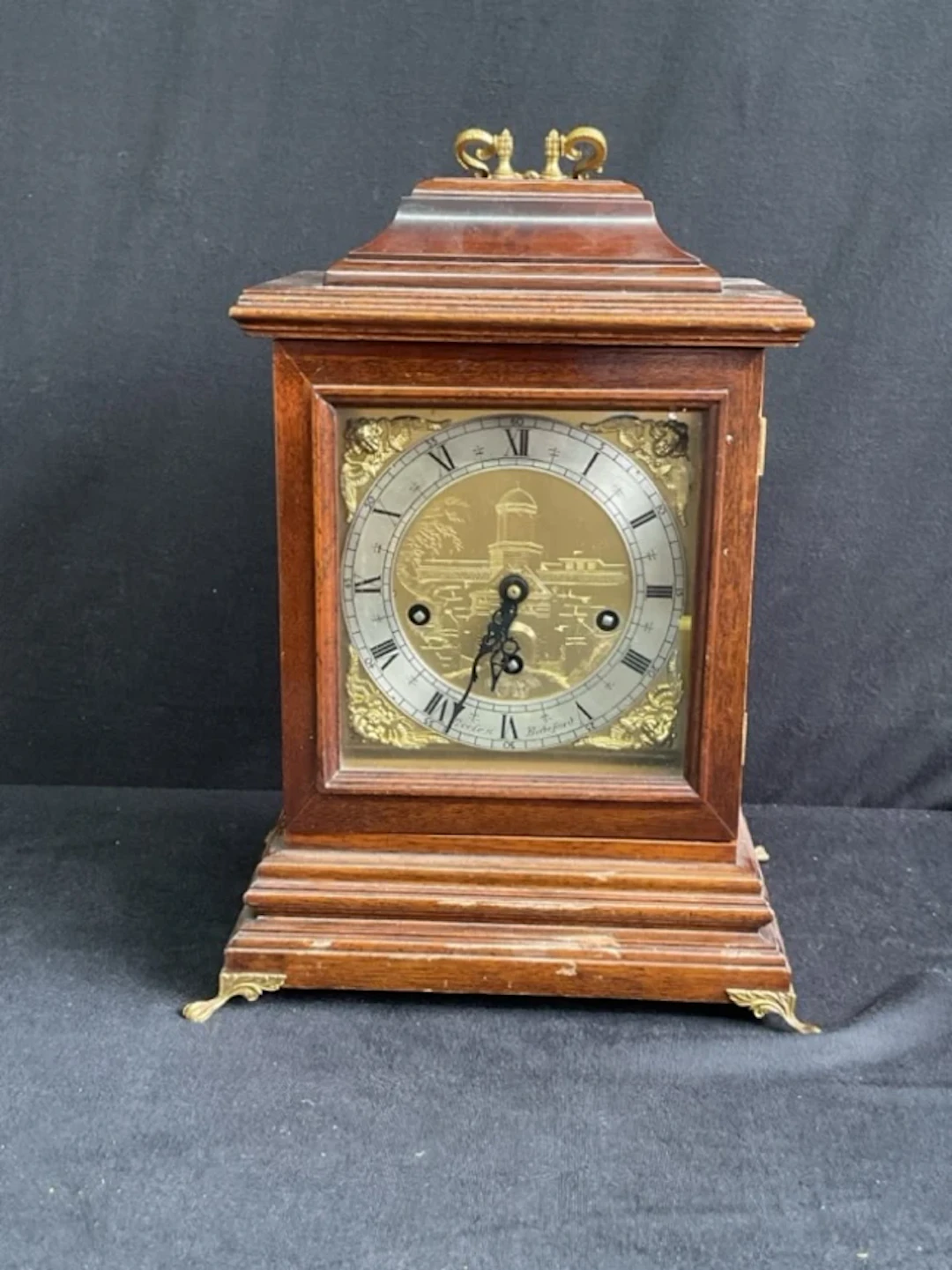 A Georgian style mahogany chiming bracket clock with gilt brass handle