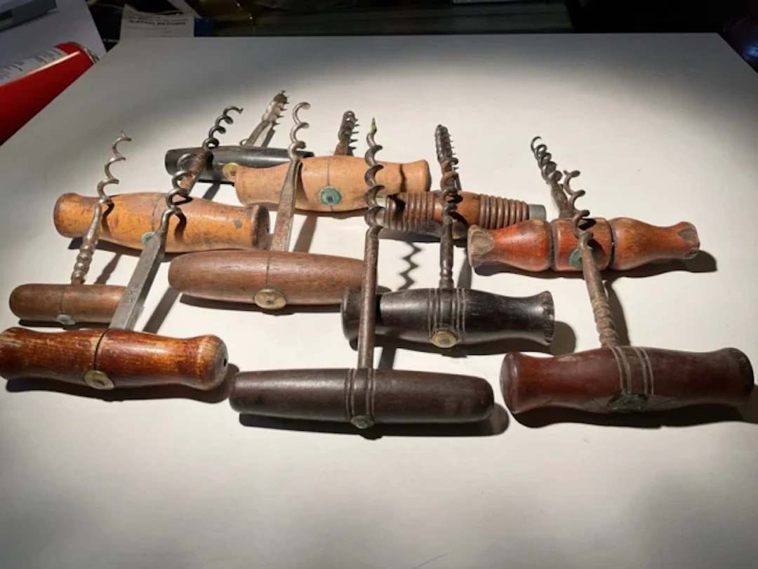 Corkscrew Collection Eleven hardwood handled direct pulls with brass