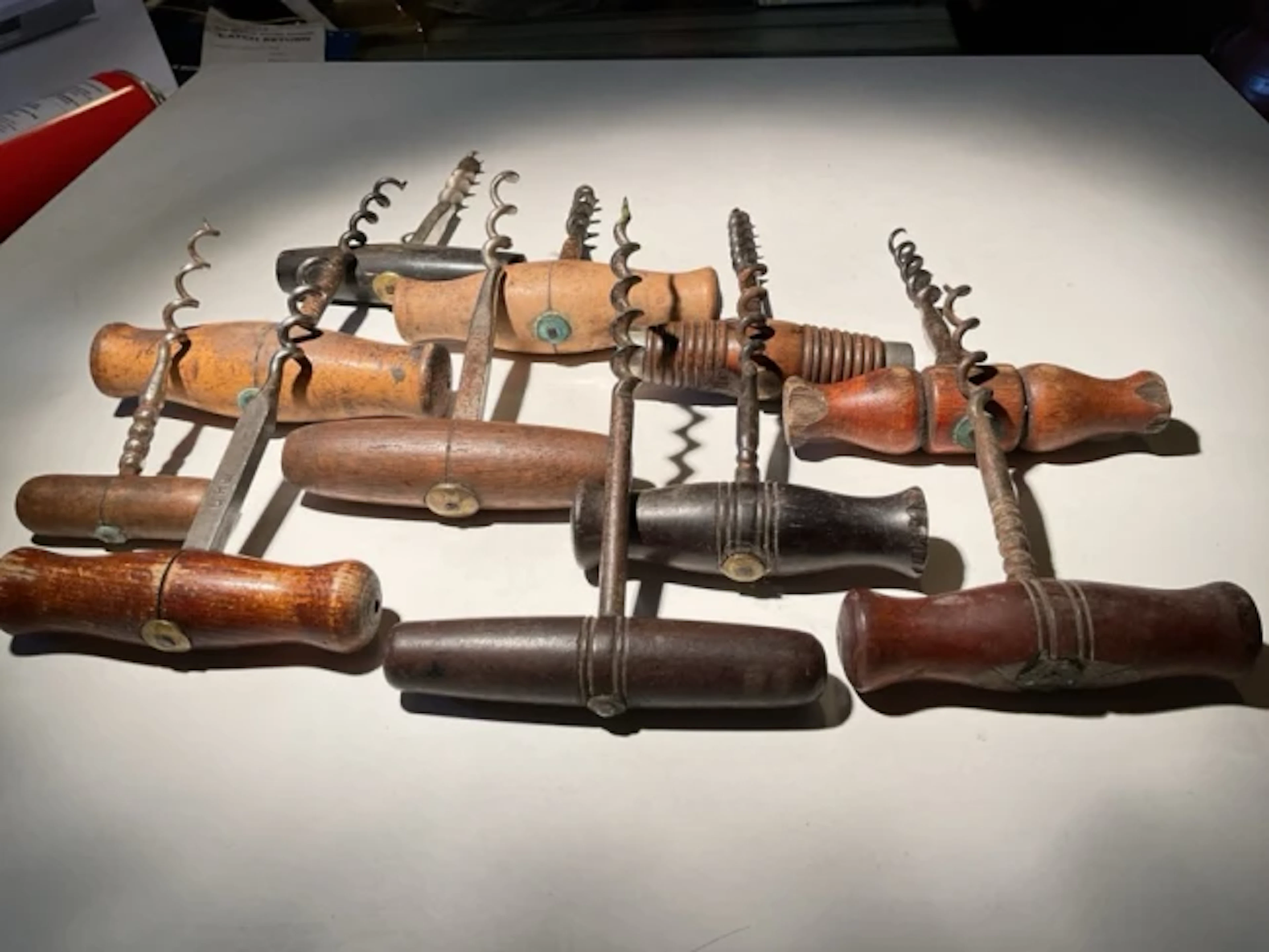 Corkscrew Collection Eleven hardwood handled direct pulls with brass