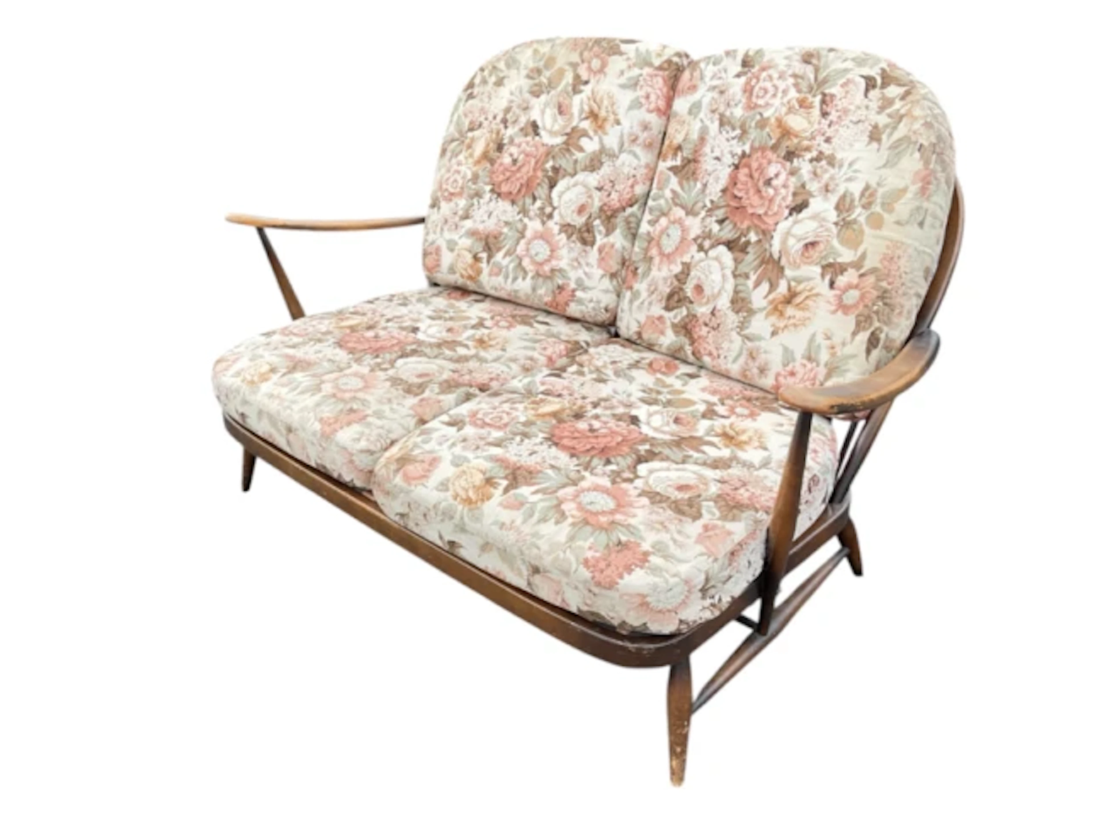 An Ercol 203 two-seater sofa with fleur-de-lys splats framed by spindles