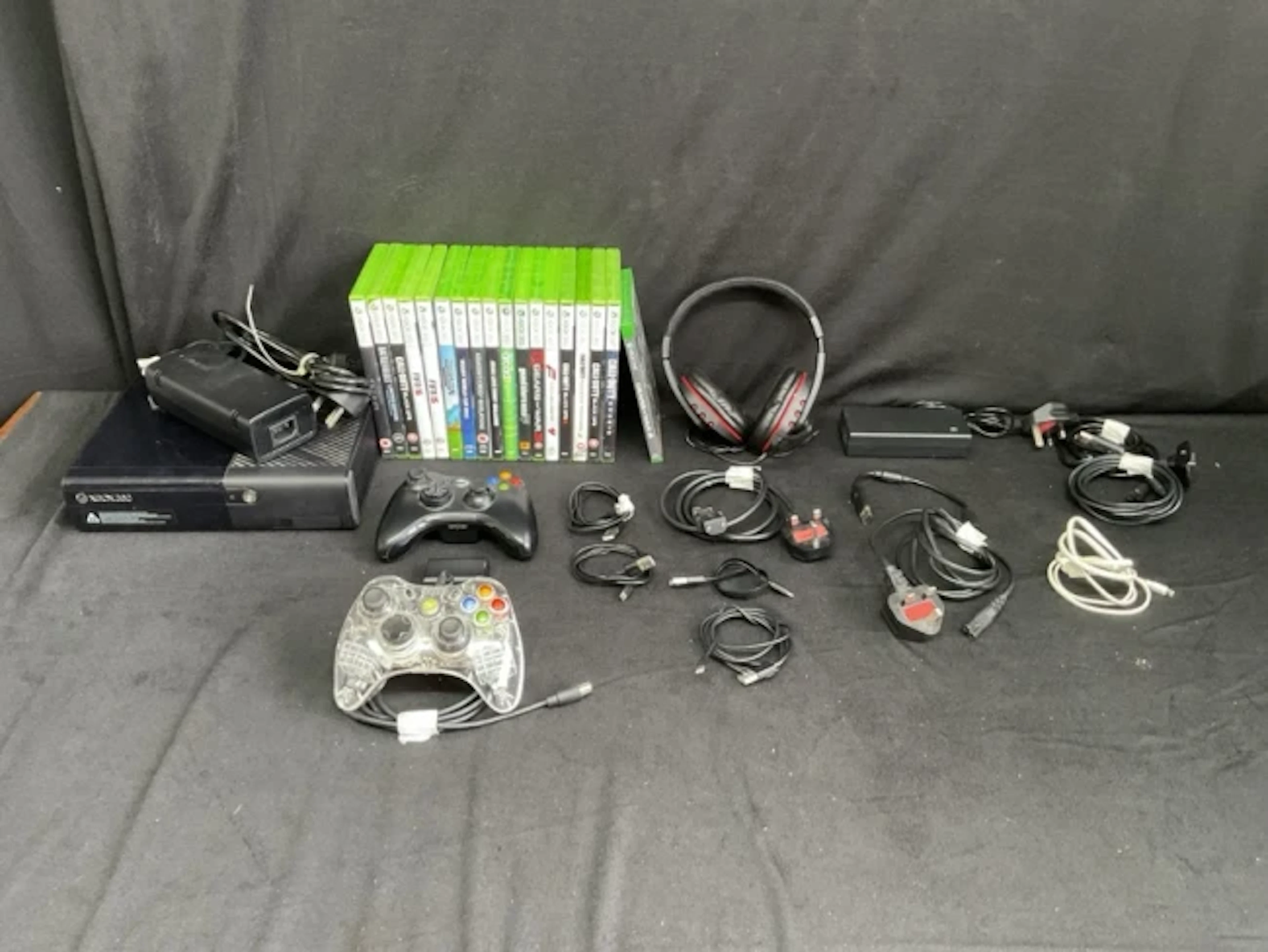An X-box 360 console with power cords, two controllers, chargers