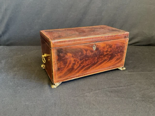 A Georgian kingwood crossbanded boxwood strung tea caddy, the interior
