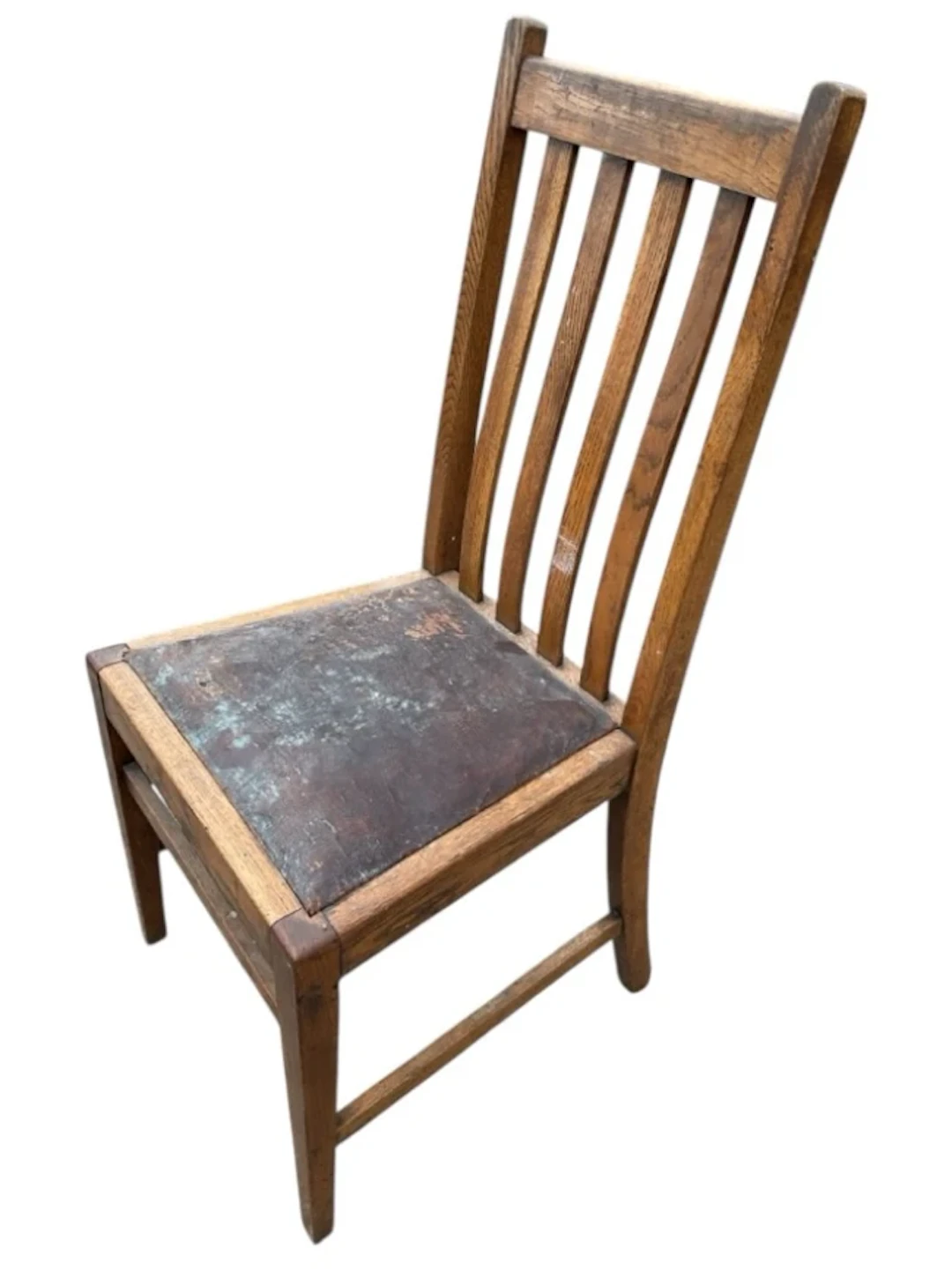 An Edwardian oak chair with rectangular slatted back above a drop-in
