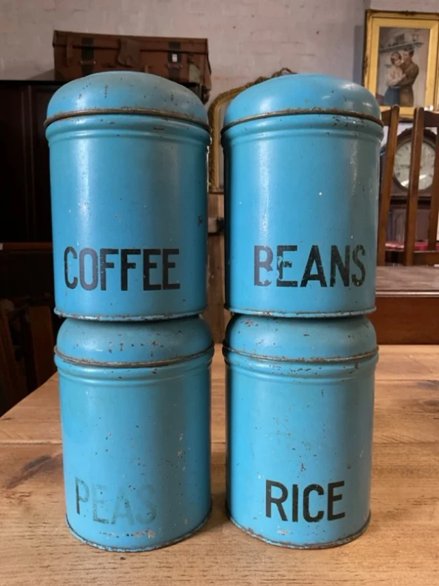 A set of four 1950s Easiwork tin storage canisters with hinged covers. (6.5in)