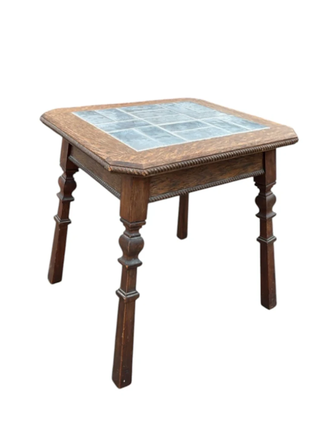 An Edwardian oak coffee table with square ropetwist moulded top inset