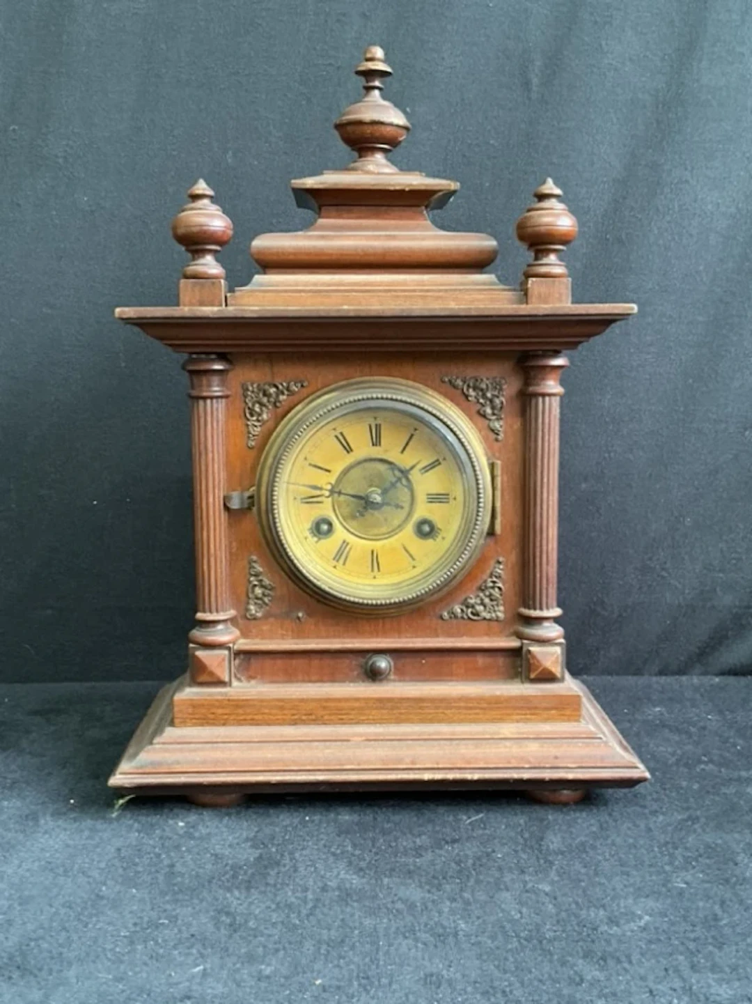 A C19th German walnut mantel clock with moulded pagoda top and turned