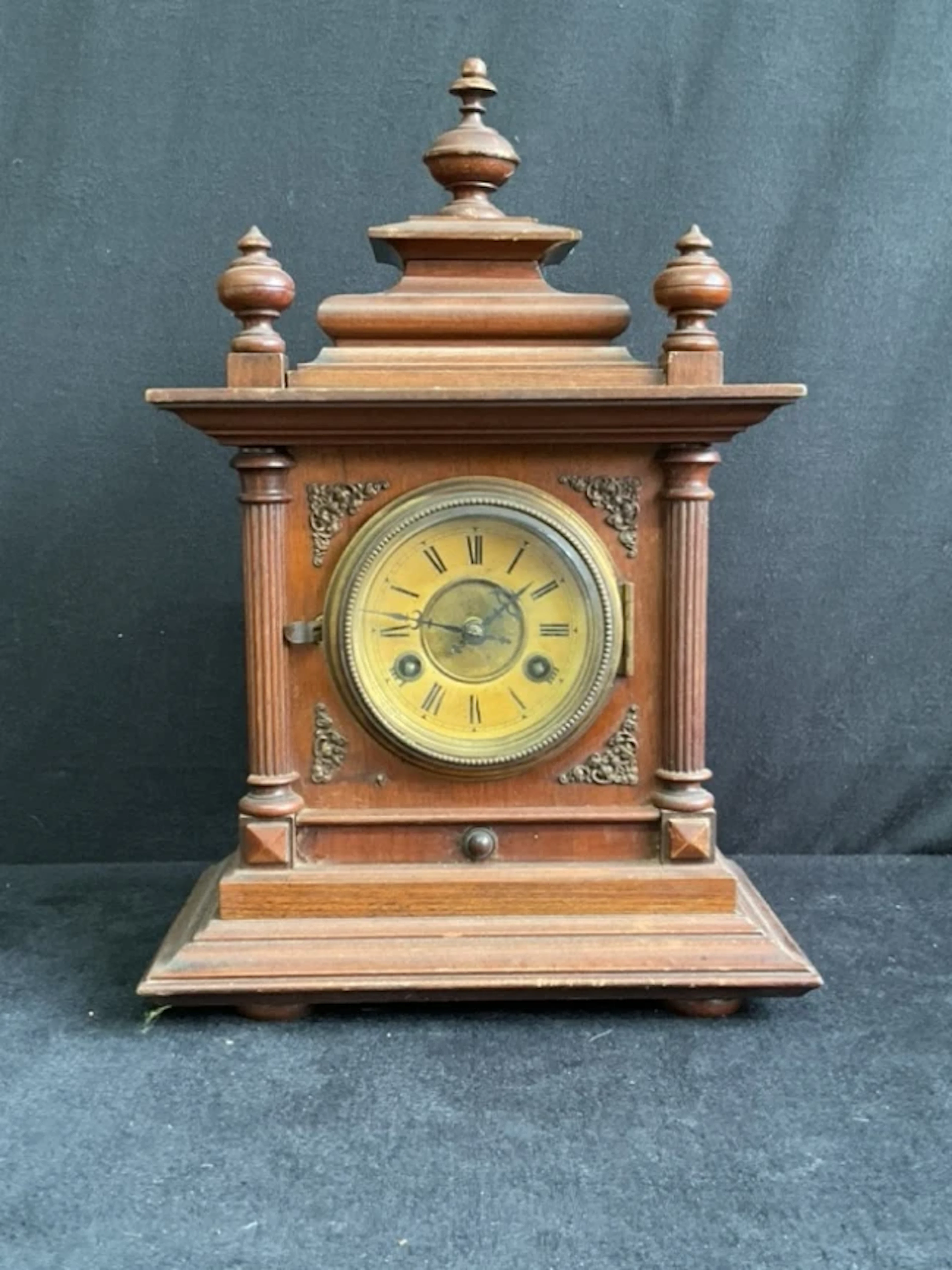 A C19th German walnut mantel clock with moulded pagoda top and turned