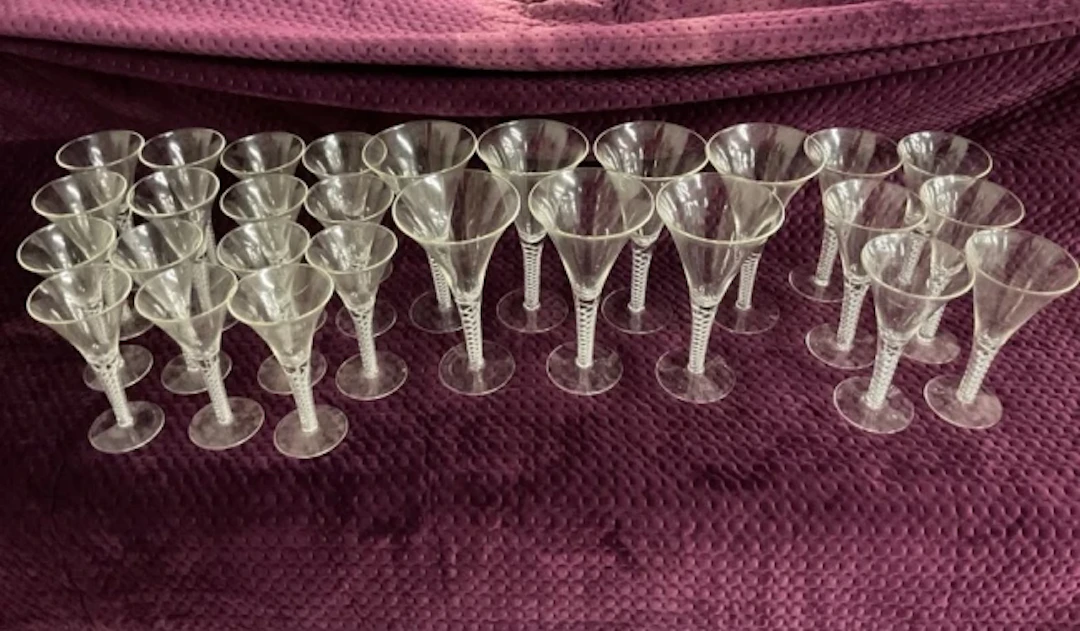 A suite of 18th century style glasses, the shaped trumpet bowls on