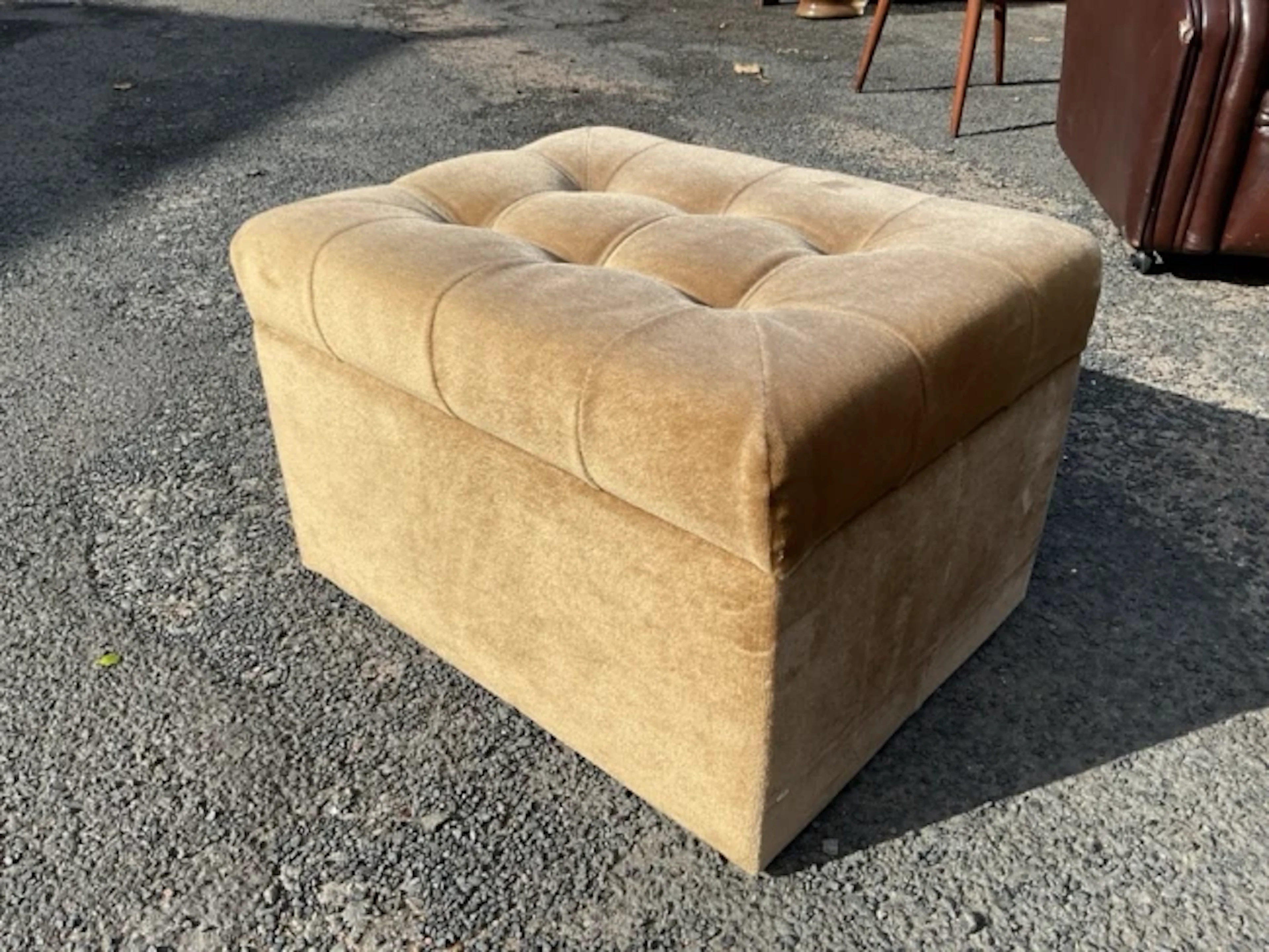 A rectangular velour covered box stool with button upholstered cushion