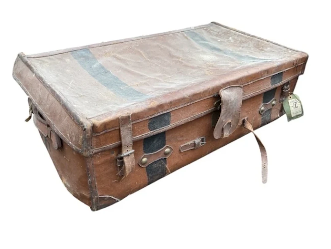 An Edwardian rectangular leather bound canvas trunk with leather straps