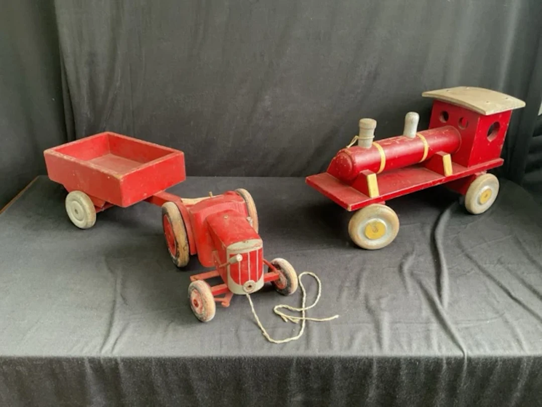 A scratch built painted wood toy farm tractor & trailor; and a similar