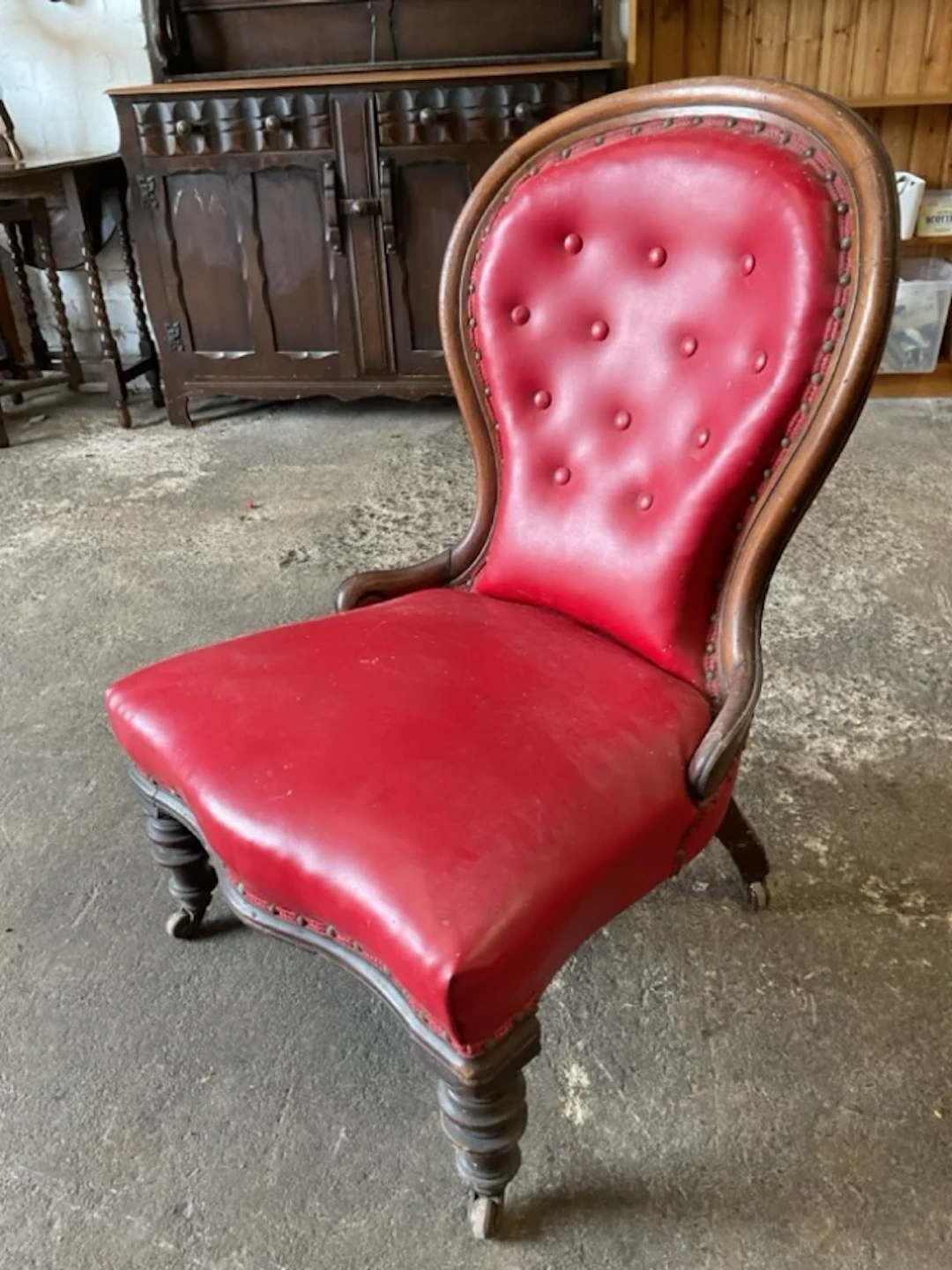 A Victorian mahogany button upholstered spoonback chair with moulded