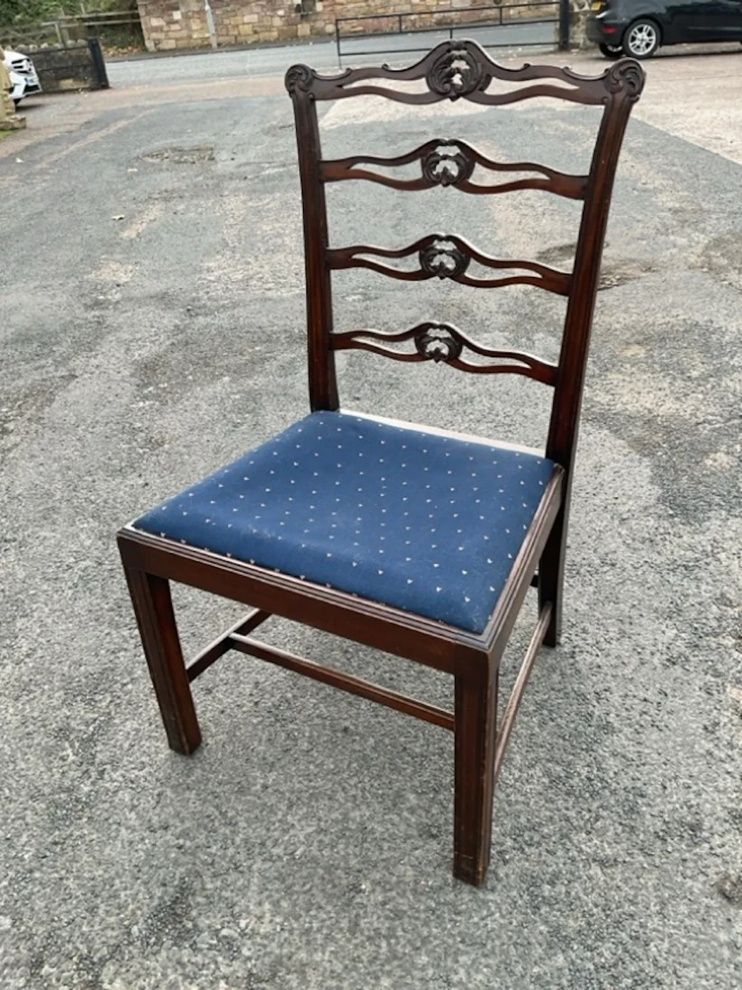 A Georgian style mahogany ladderback chair with pierced scroll carved