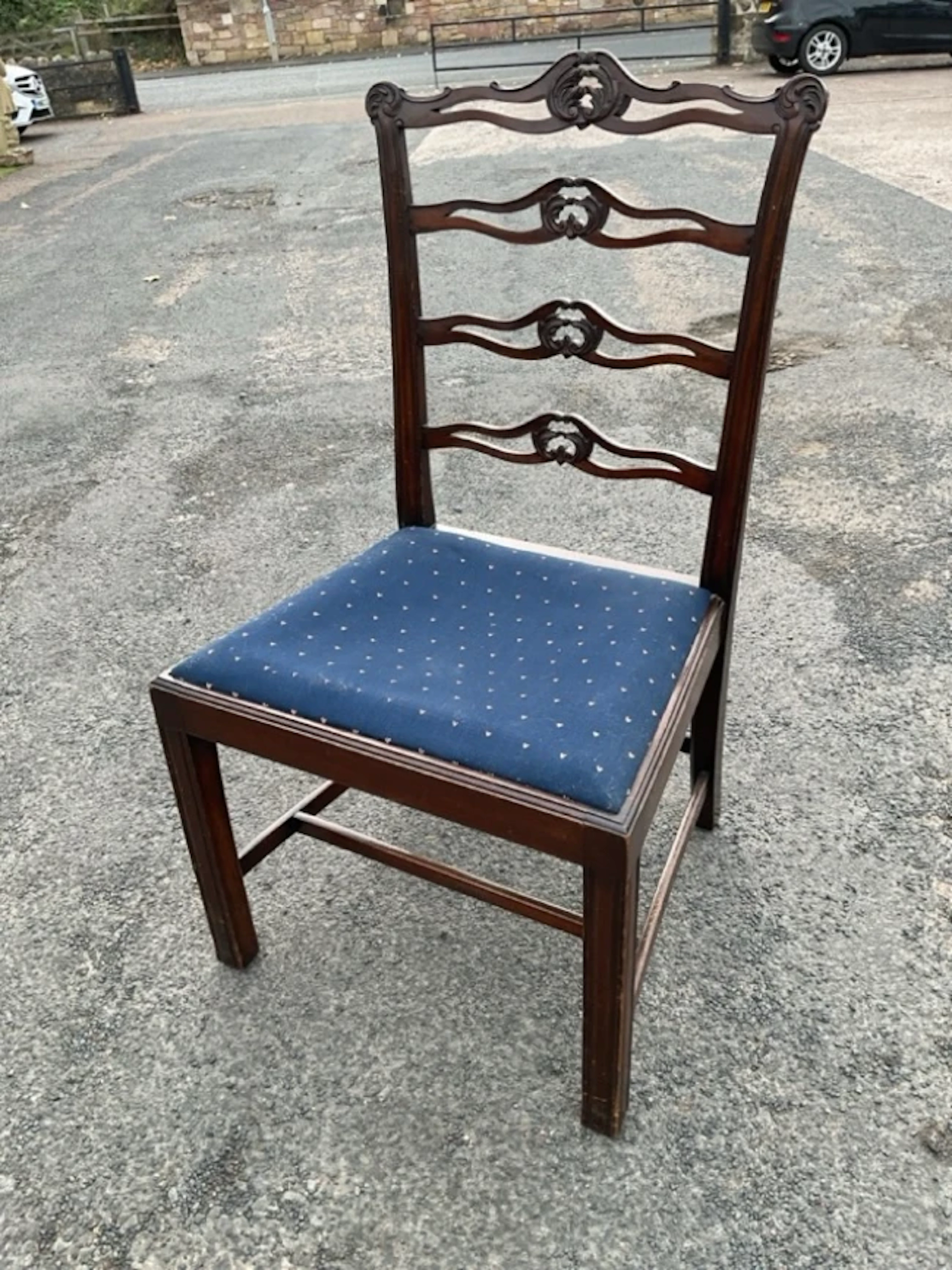 A Georgian style mahogany ladderback chair with pierced scroll carved