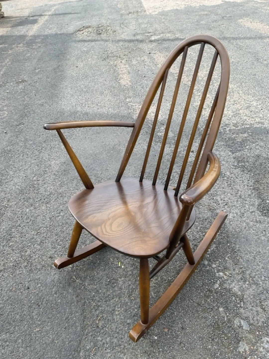 An Ercol rocking chair with hooped spindleback and flared rounded