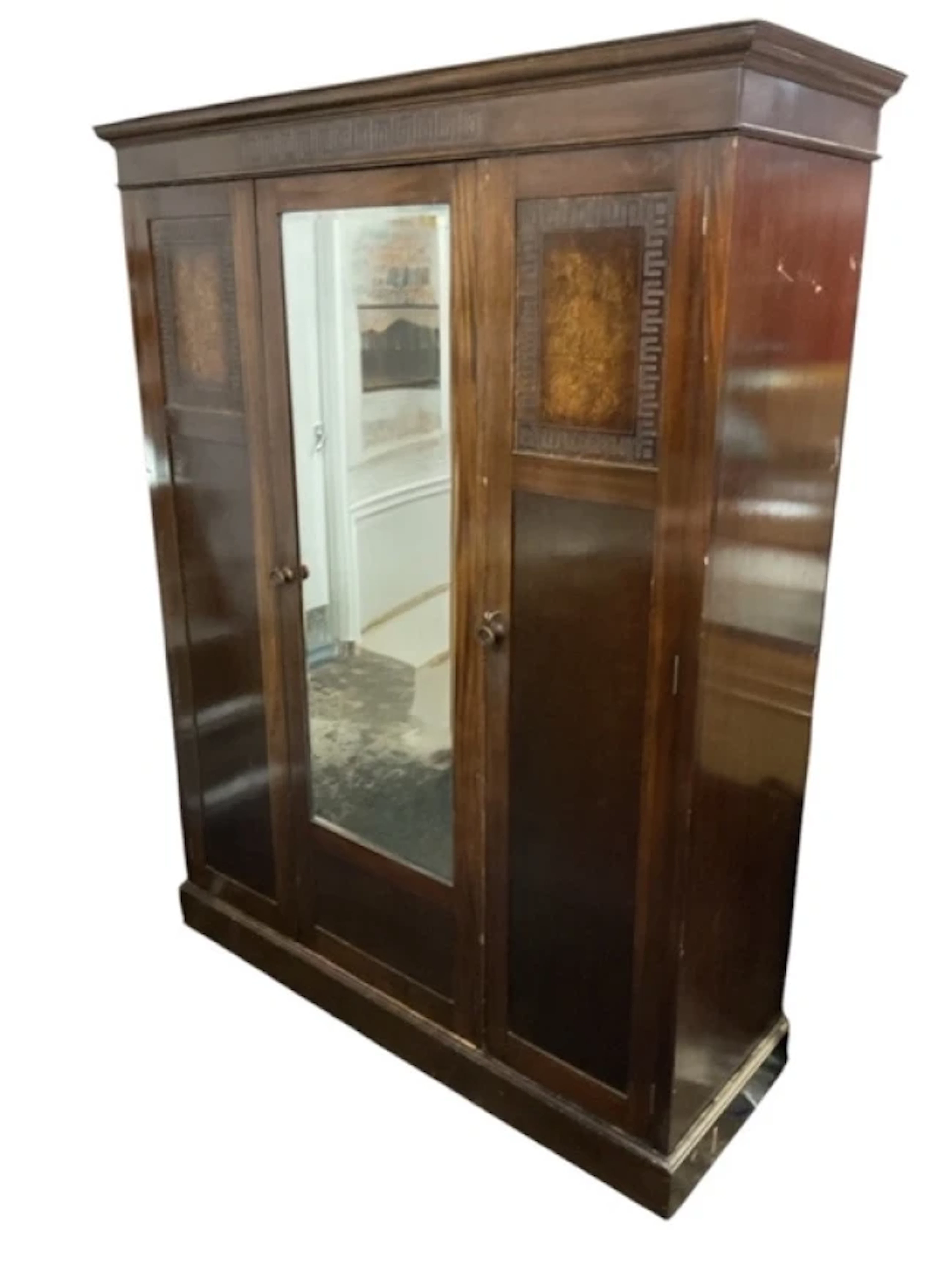 An Edwardian mahogany wardrobe with moulded cornice above a greek