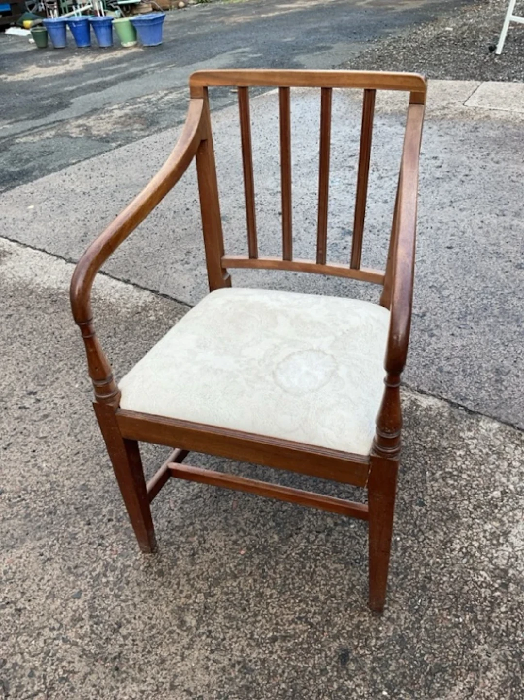 A mahogany elbow chair with lathe spindles to back and downswept arms