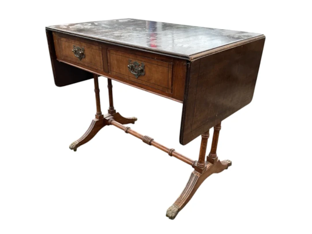 A mahogany coffee table modelled as a small sofa table with ebony