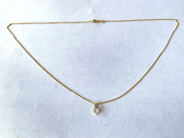 An 18ct gold diamond necklace, the heart shaped stone of approximately