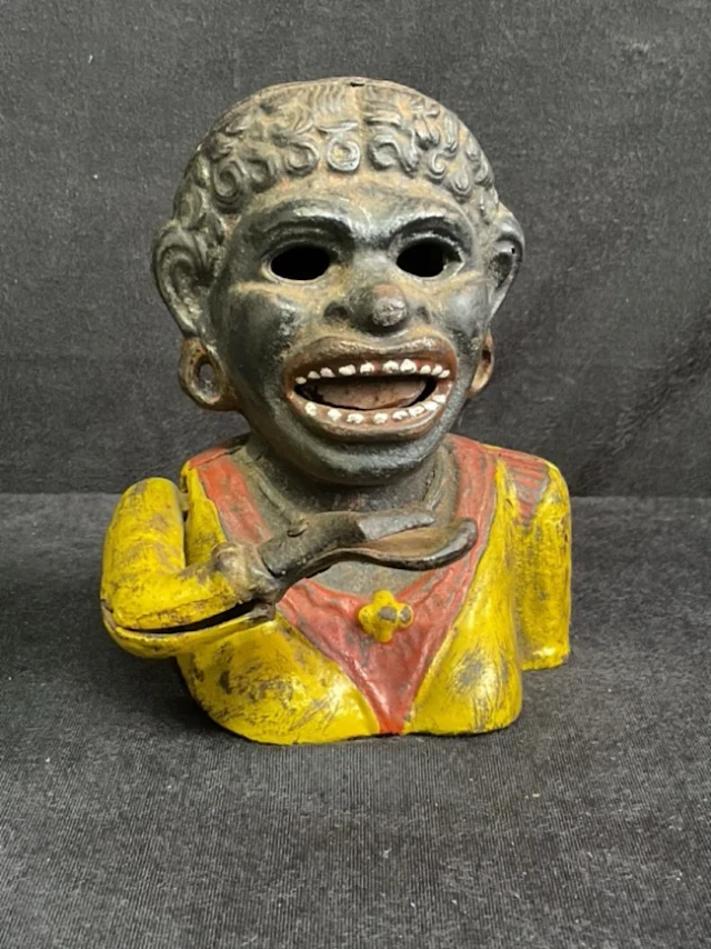 An cast iron mechanical Dinah novelty money bank, in the form of a