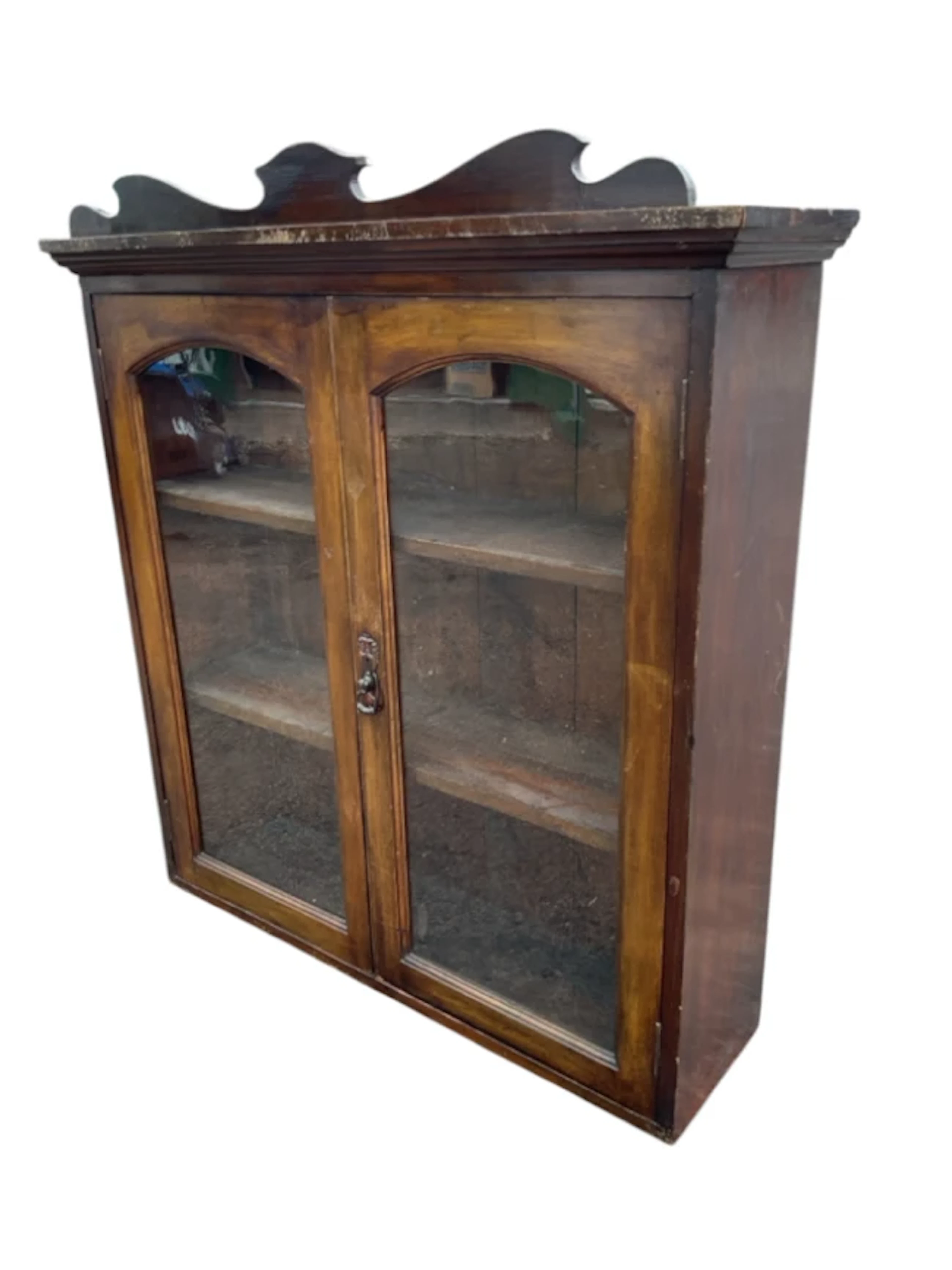 An Edwardian stained hardwood cabinet with shaped crest and moulded
