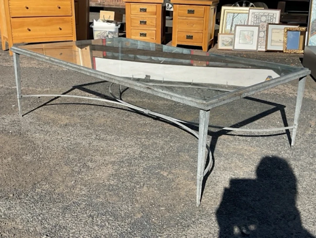 A contemporary plate-glass topped rectangular coffee table on patinated