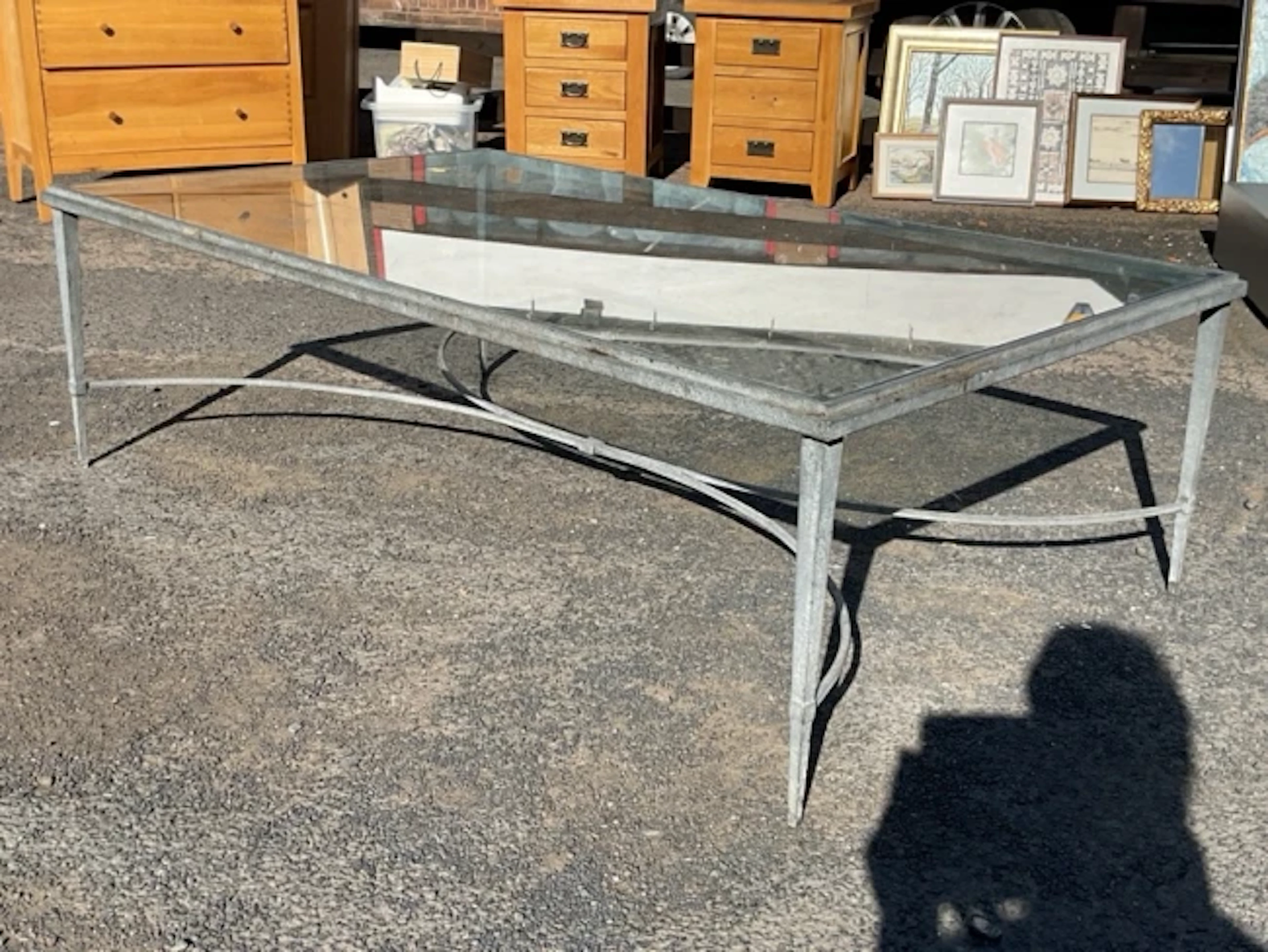 A contemporary plate-glass topped rectangular coffee table on patinated