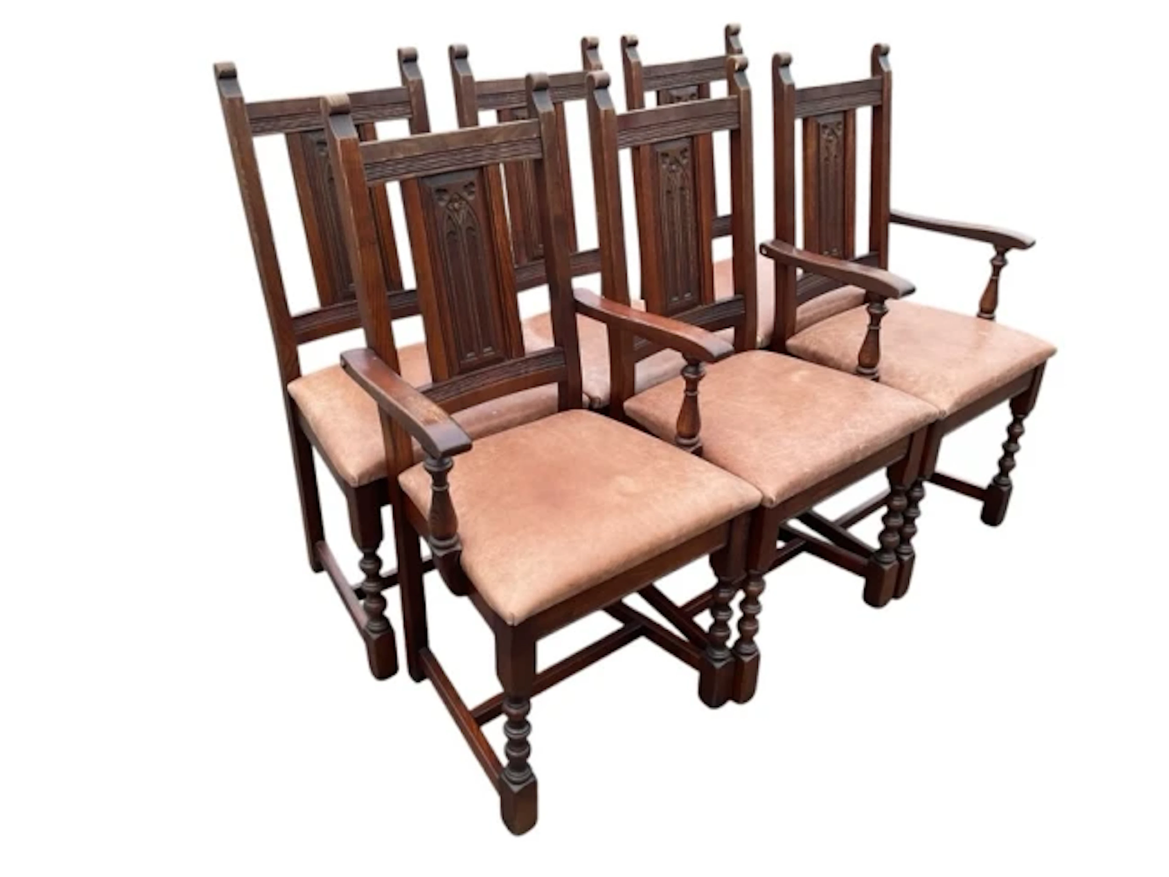 A set of six oak dining chairs with rectangular backs having gothic