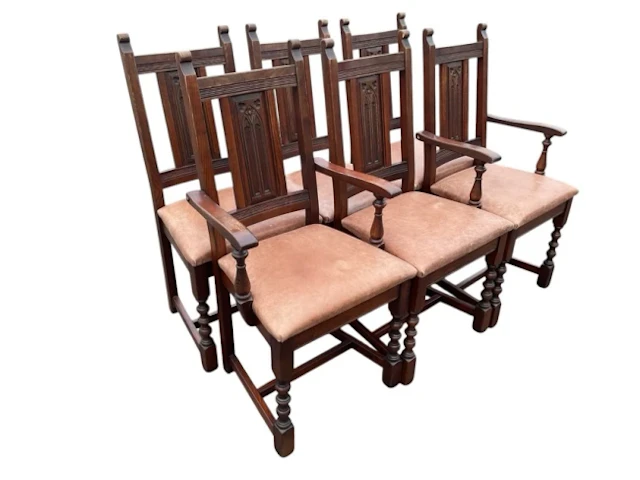 A set of six oak chairs with rectangular backs having gothic arch
