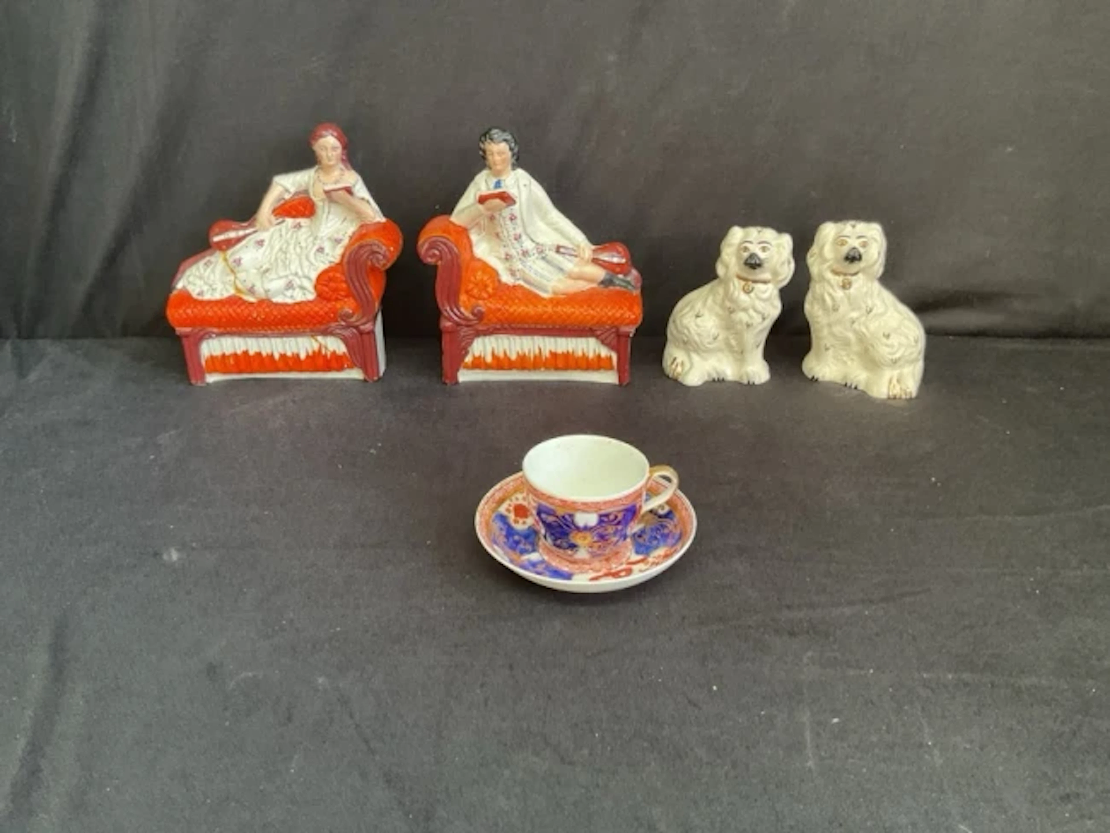 A pair of Staffordshire flatback figures of a lady and gentleman reclining