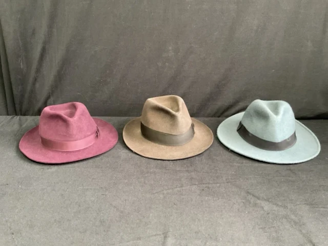An American Stetson burgundy fur felt trilby - size 7 1/8; a German