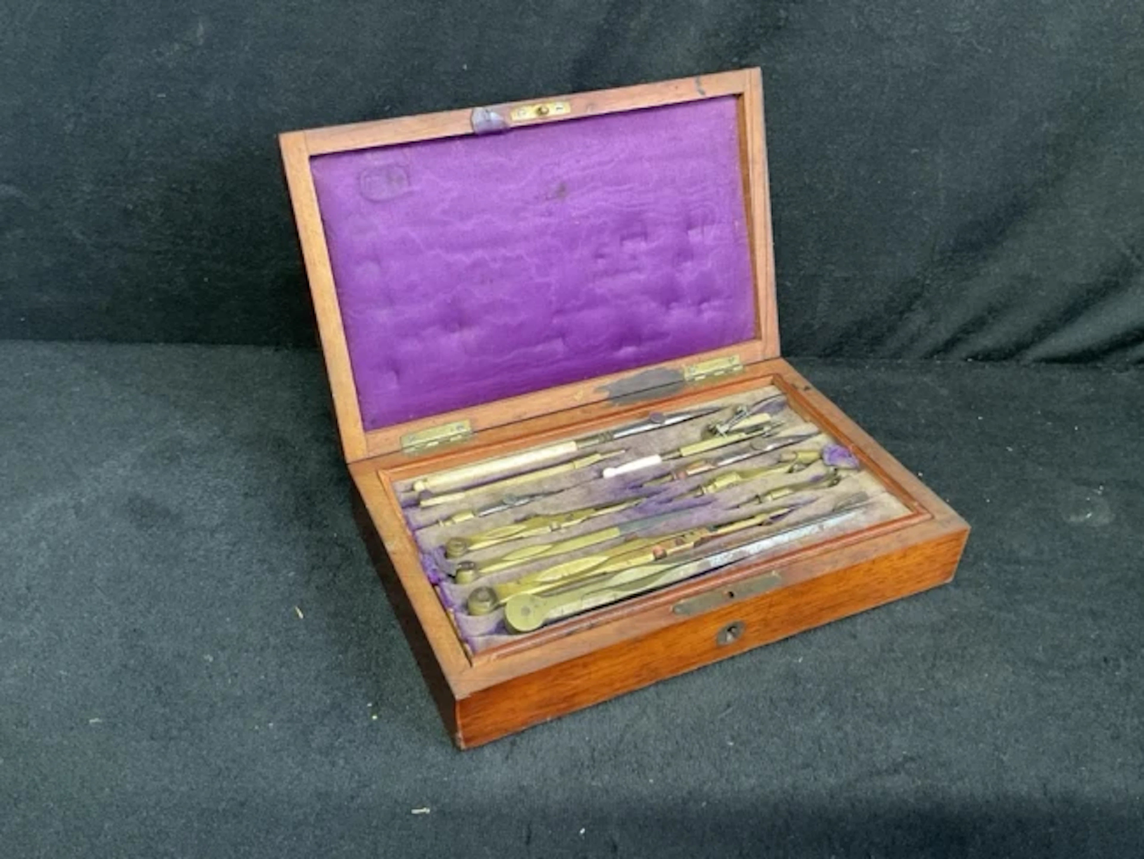 A Victorian rosewood cased set of drawing instruements - mainly brass