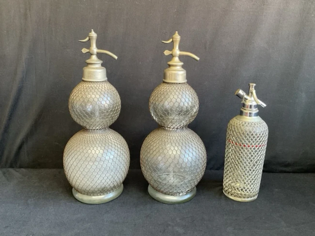 A pair of French mesh covered glass gourd shaped flasks with pewter