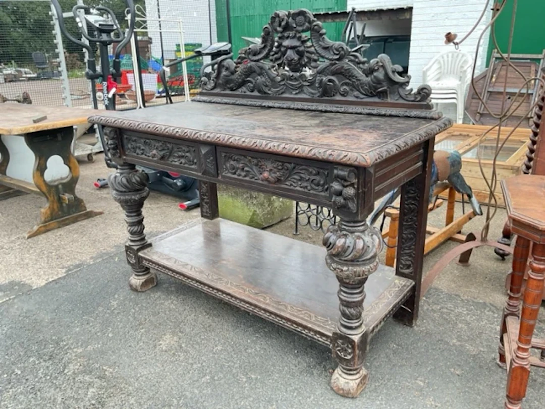 A Victorian carved oak sideboard with lionmask carved pierced back