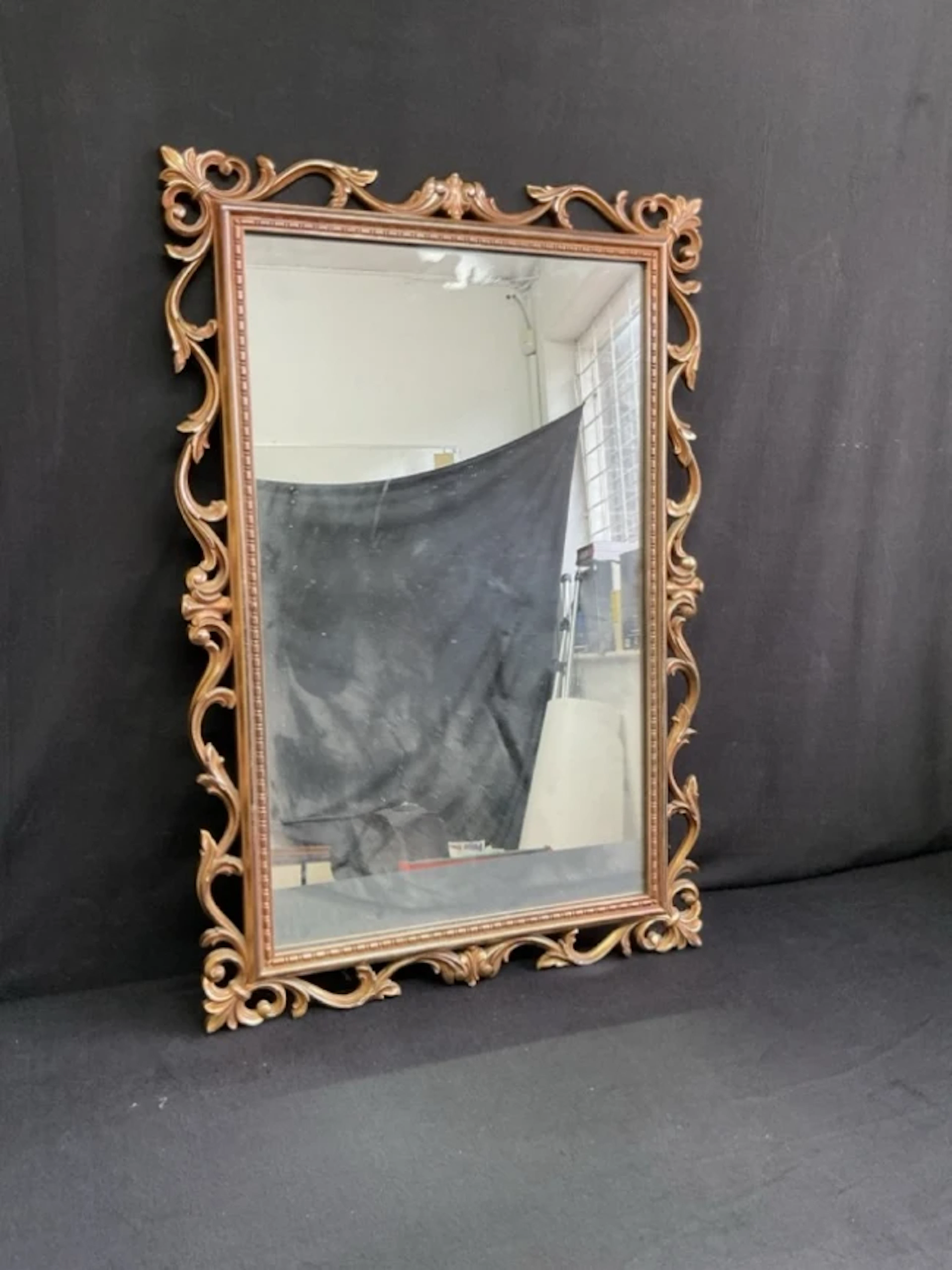 A Georgian style rectangular mirror with rococo pierced foliate scroll