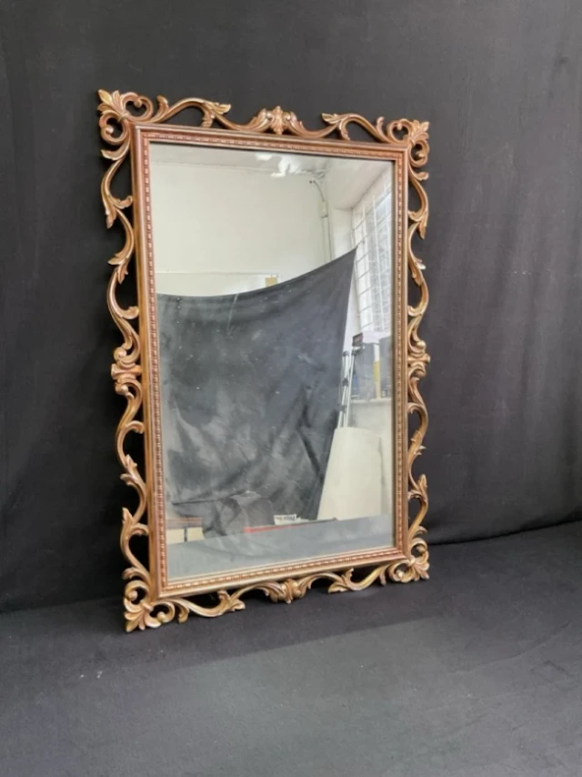 A Georgian style rectangular mirror with rococo pierced foliate scroll