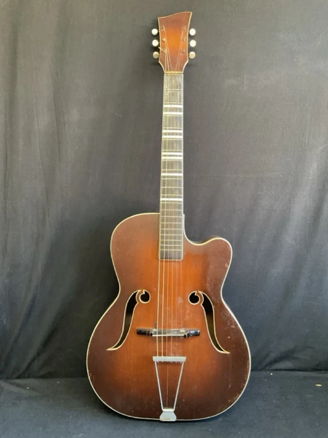 A 60s Melodija arched top acoustic guitar with ebonised neck, shaped