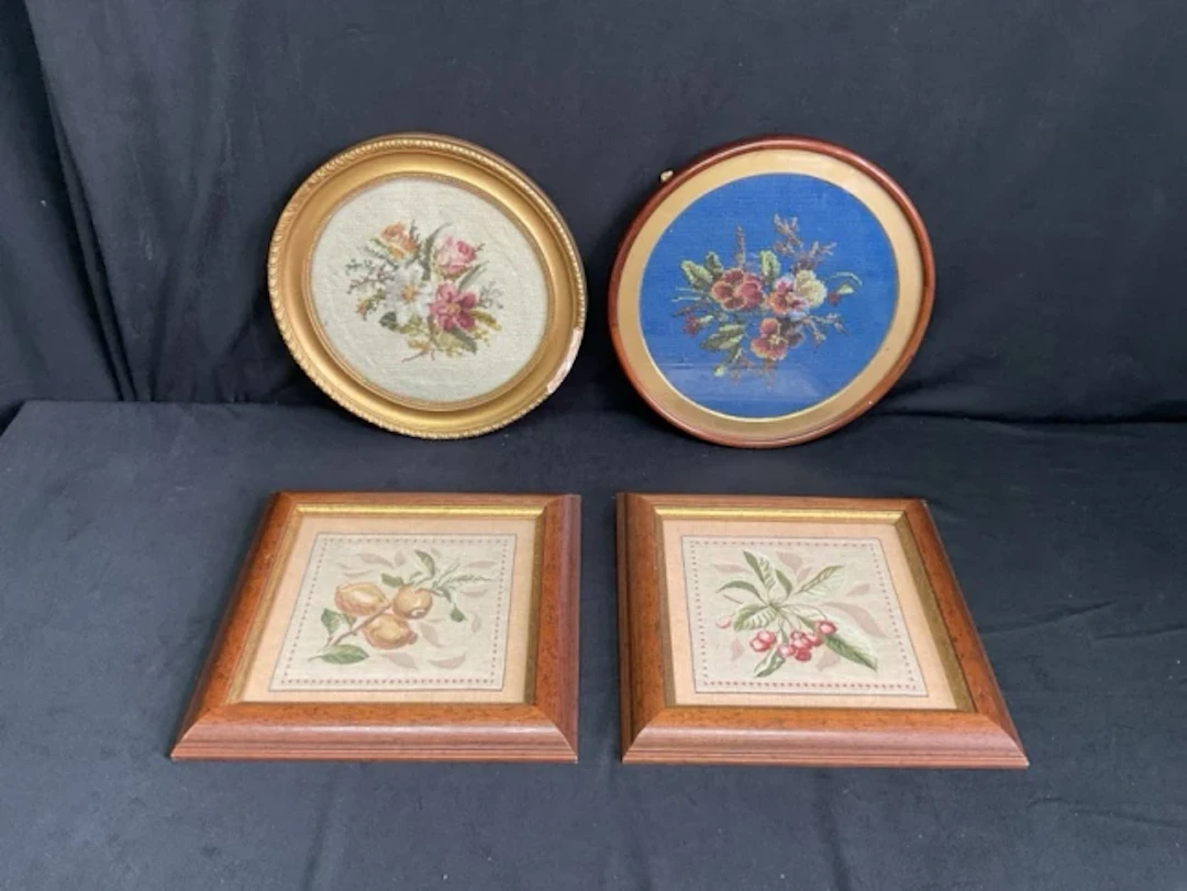A circular Victorian woolwork tapestry panel of a posy of flowers