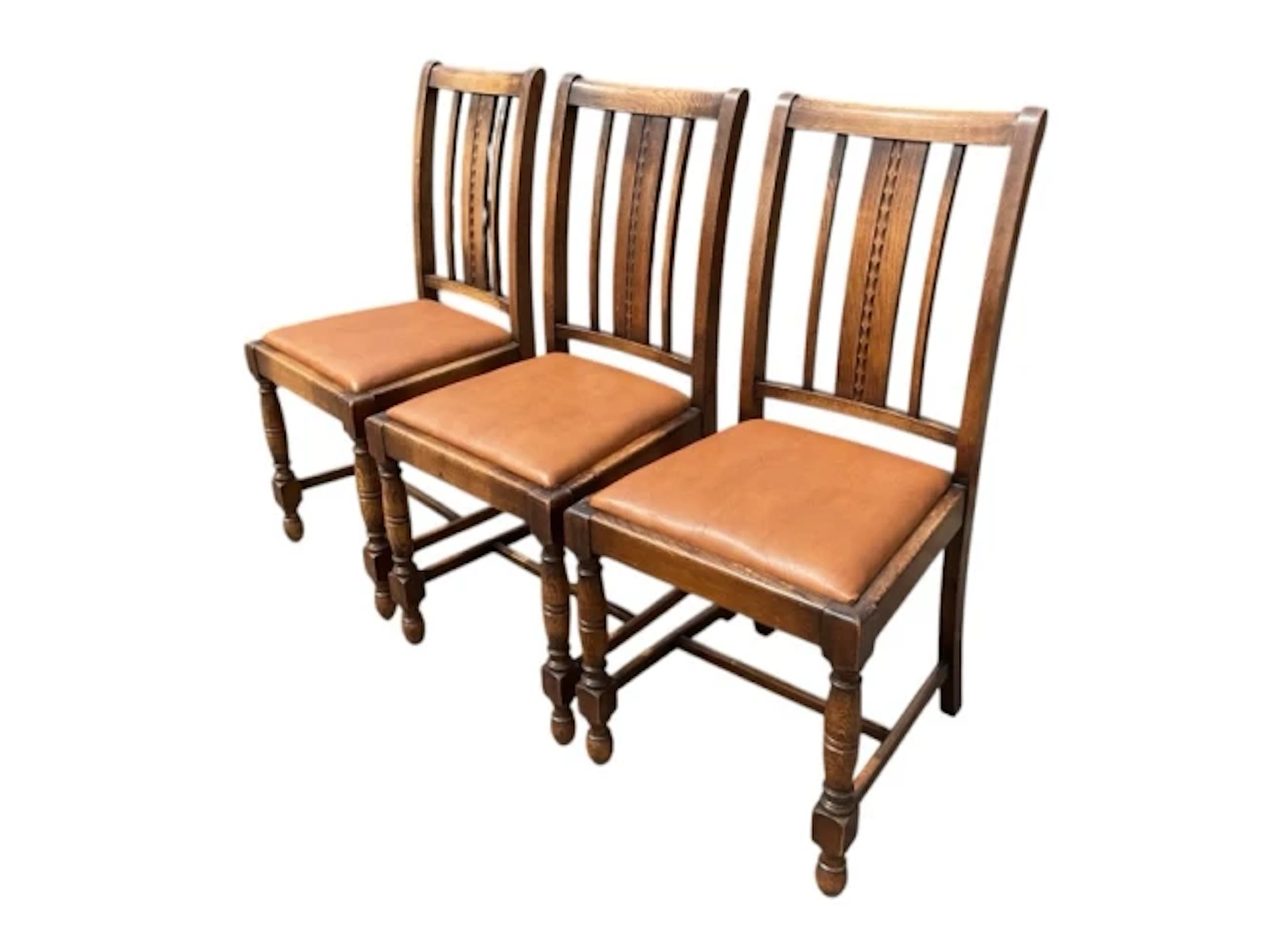 A set of three oak dining chairs with Chapman & Co labels, having