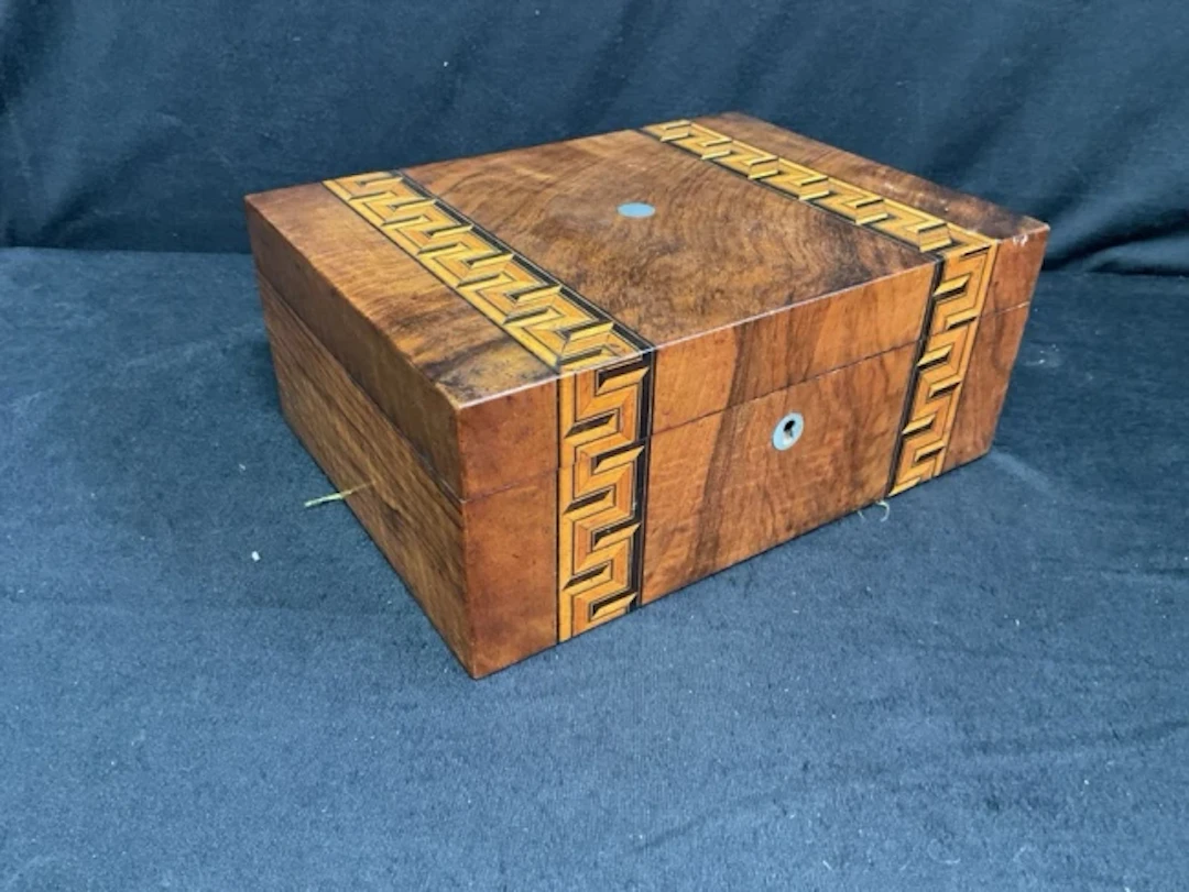 A Victorian walnut box inlaid with greek key style banding, having