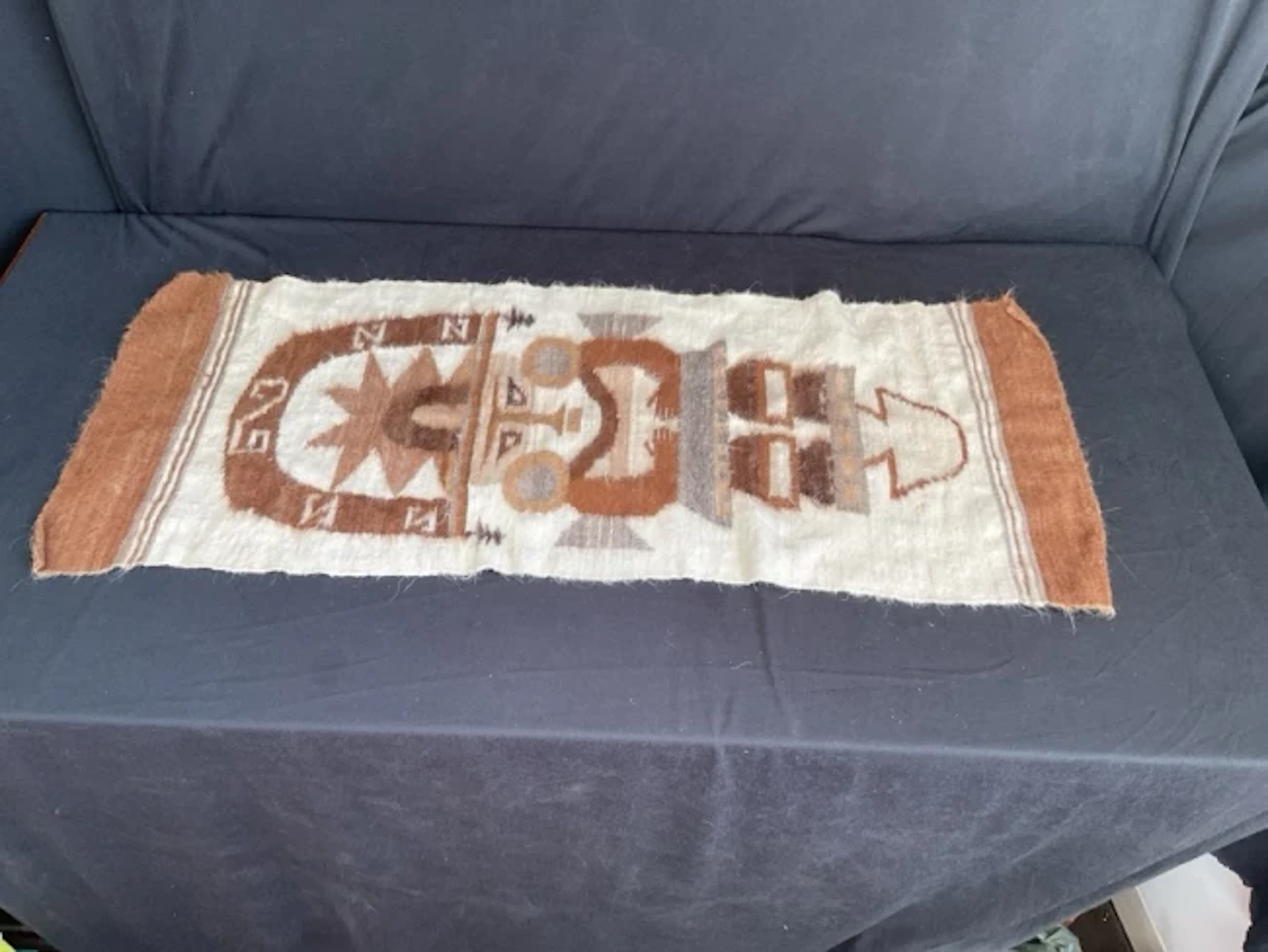 A Peruvian handwoven alpaca tapestry wall hanging depicting a traditional