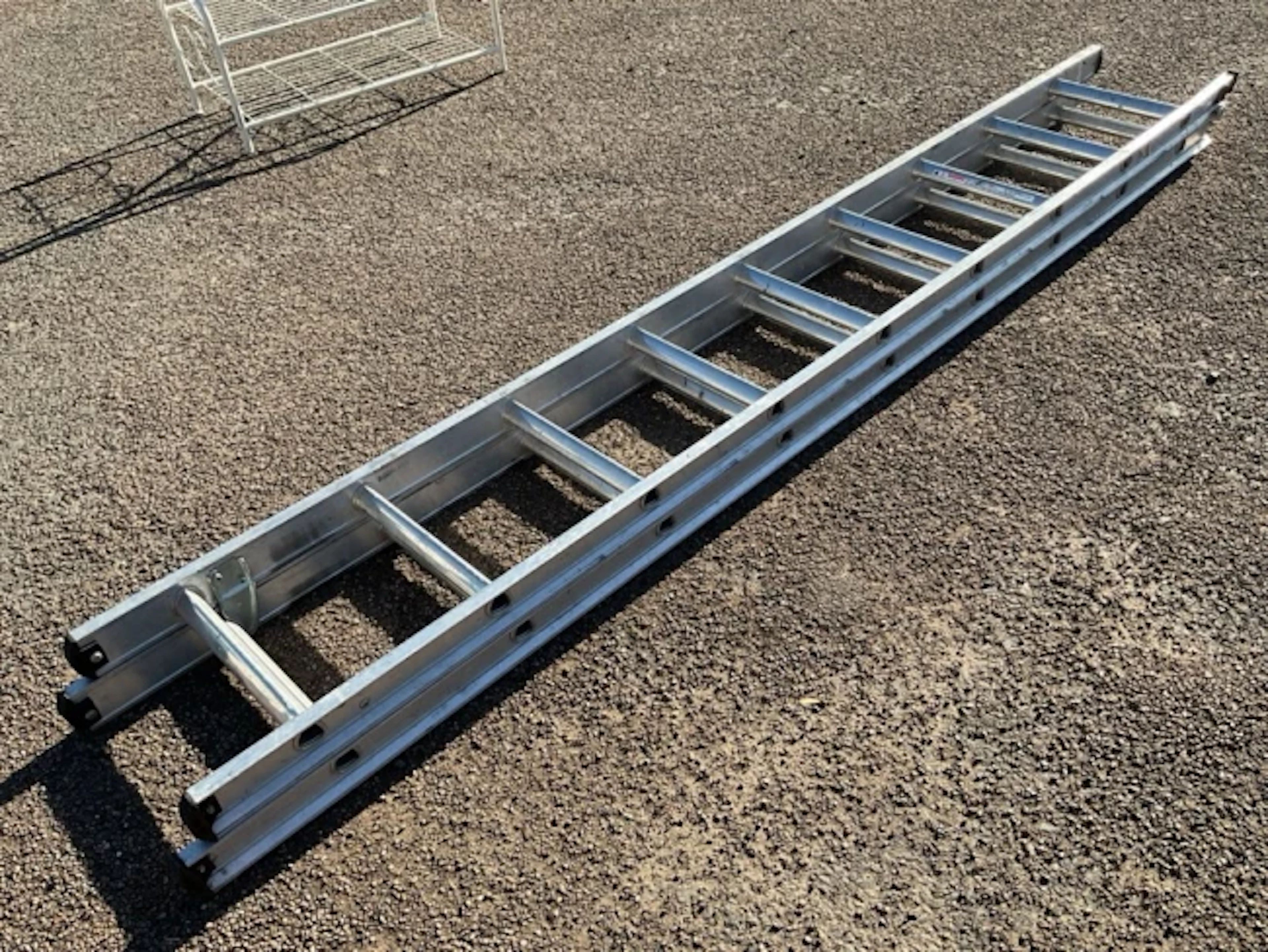 A two-section aluminium extending ladder, each piece with nine triangular
