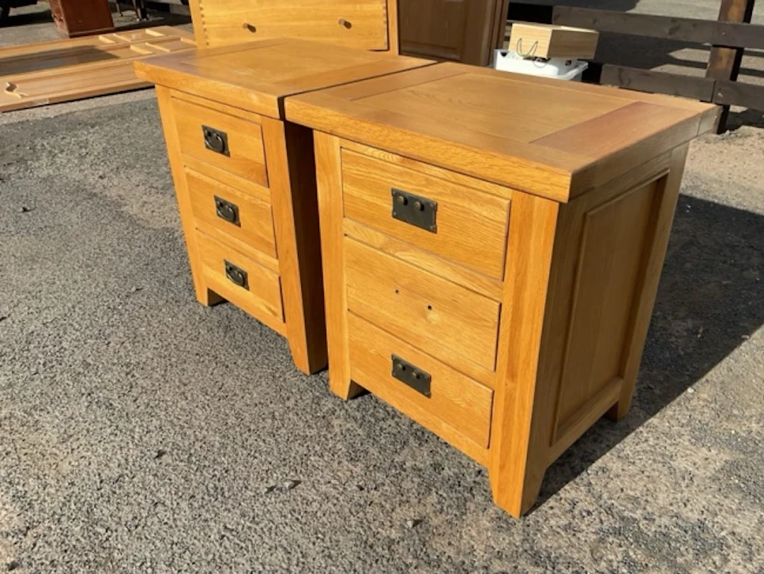 A pair of contemporary oak cabinets each with three drawers having