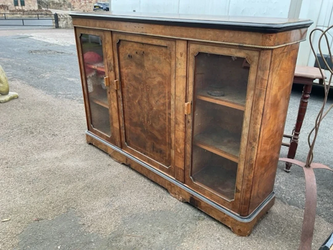 A Victorian walnut credenza, the rounded top with ebonised moulding