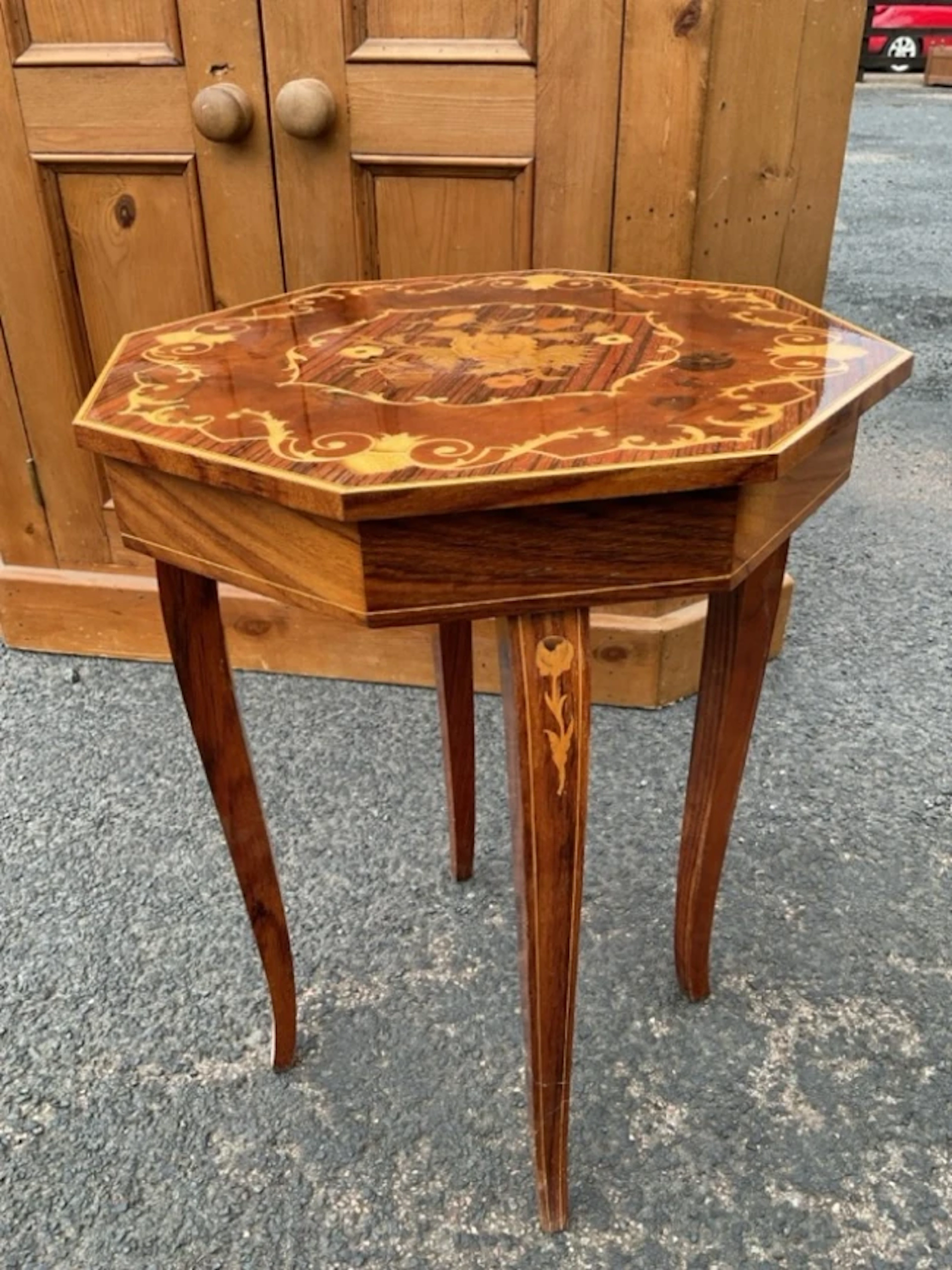 An octagonal Italian marquetry musical occasional table with foliate