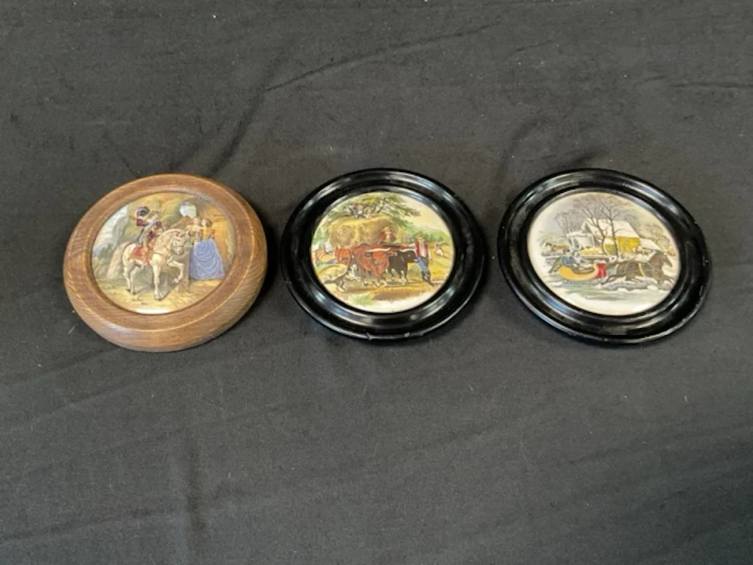 A Victorian oak framed Prattware pot lid printed with a mounted cavalier