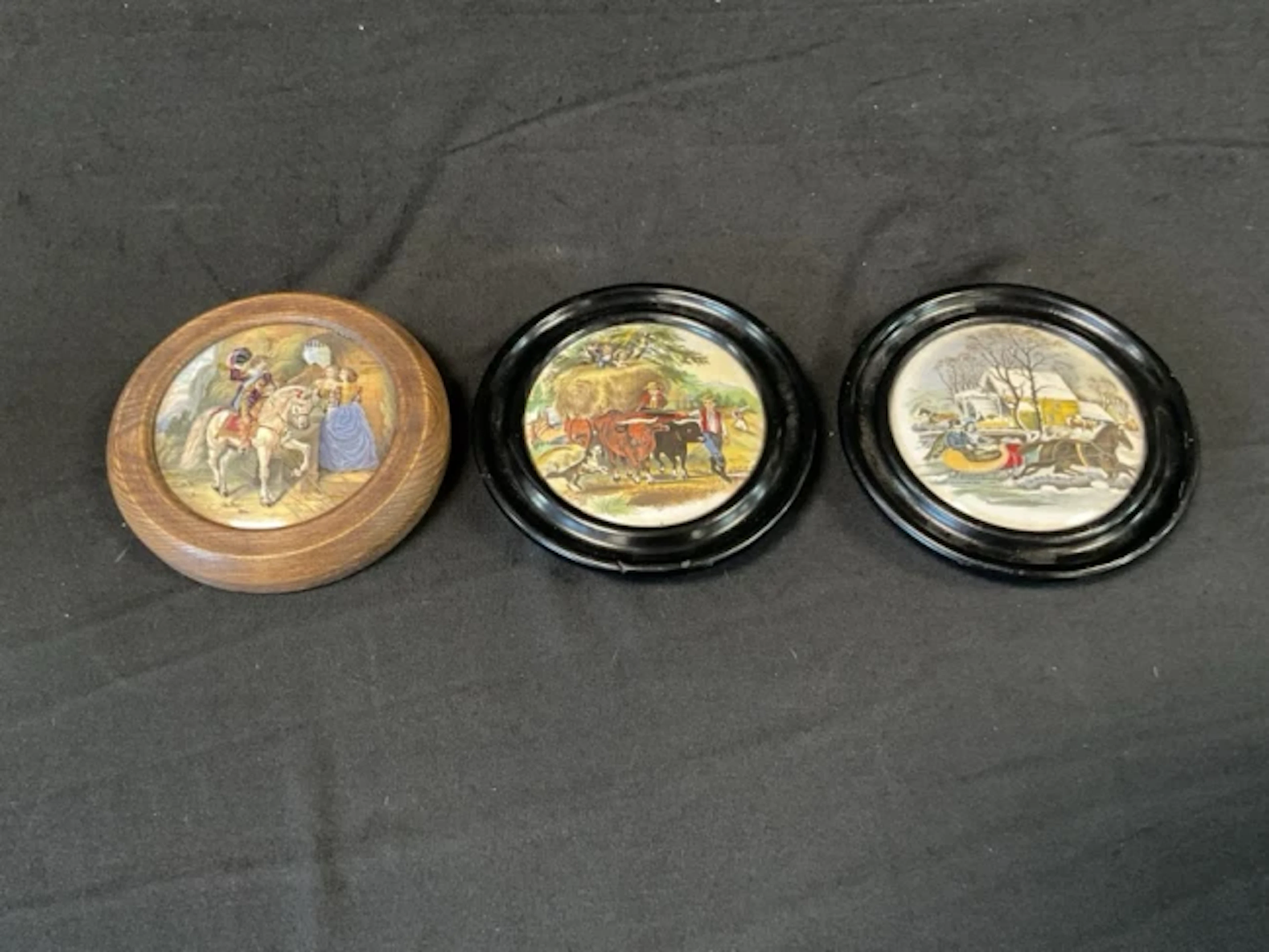 A Victorian oak framed Prattware pot lid printed with a mounted cavalier